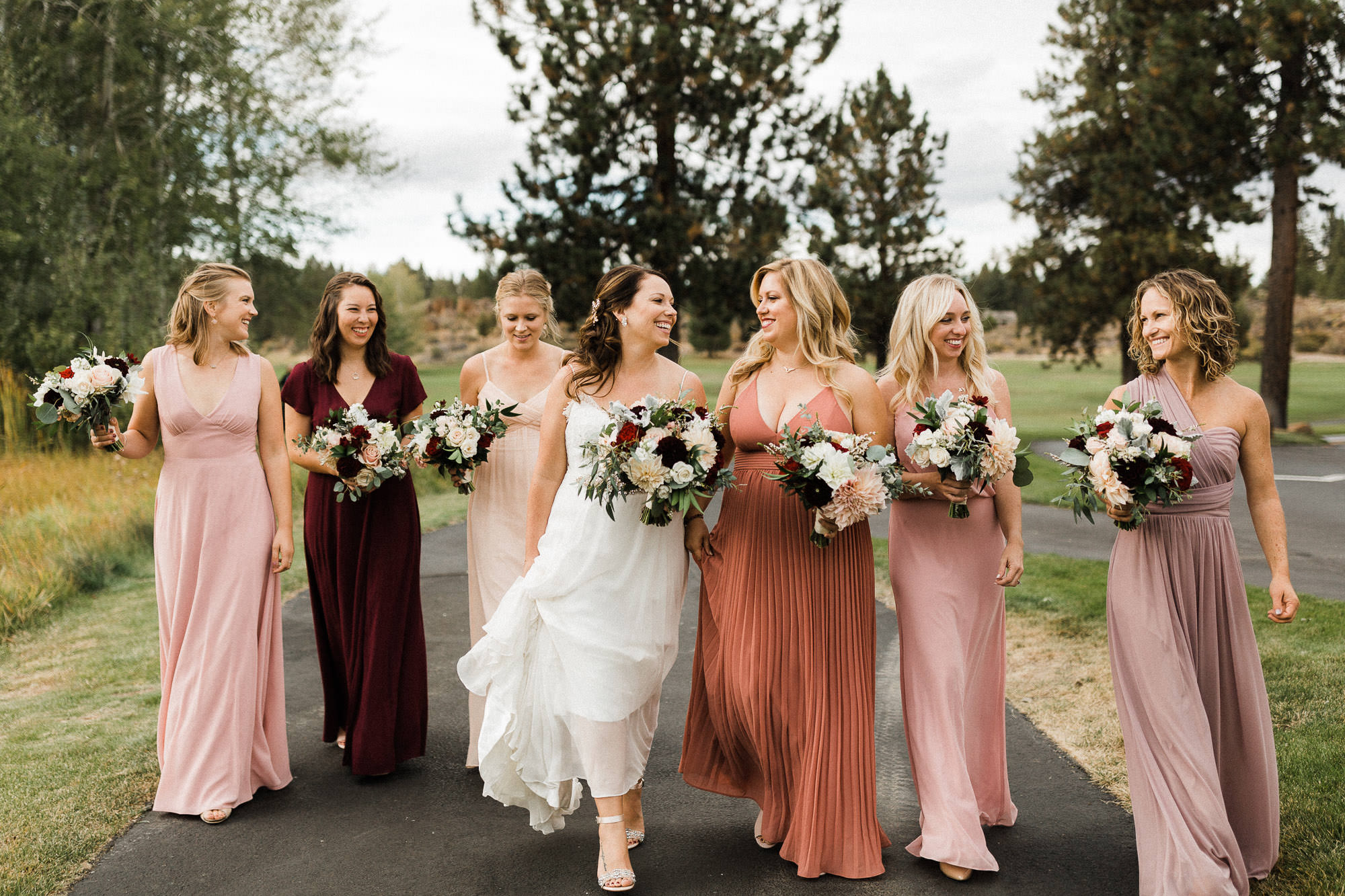Bridal party walks down a path at Broken Top Club in Bend, Oregon