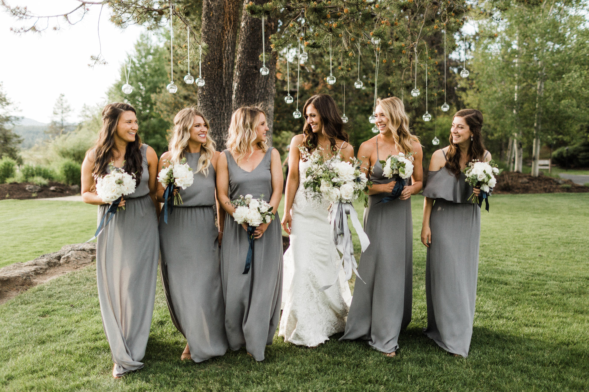 Bridesmaids laugh and walk at Sunriver Resort in Oregon