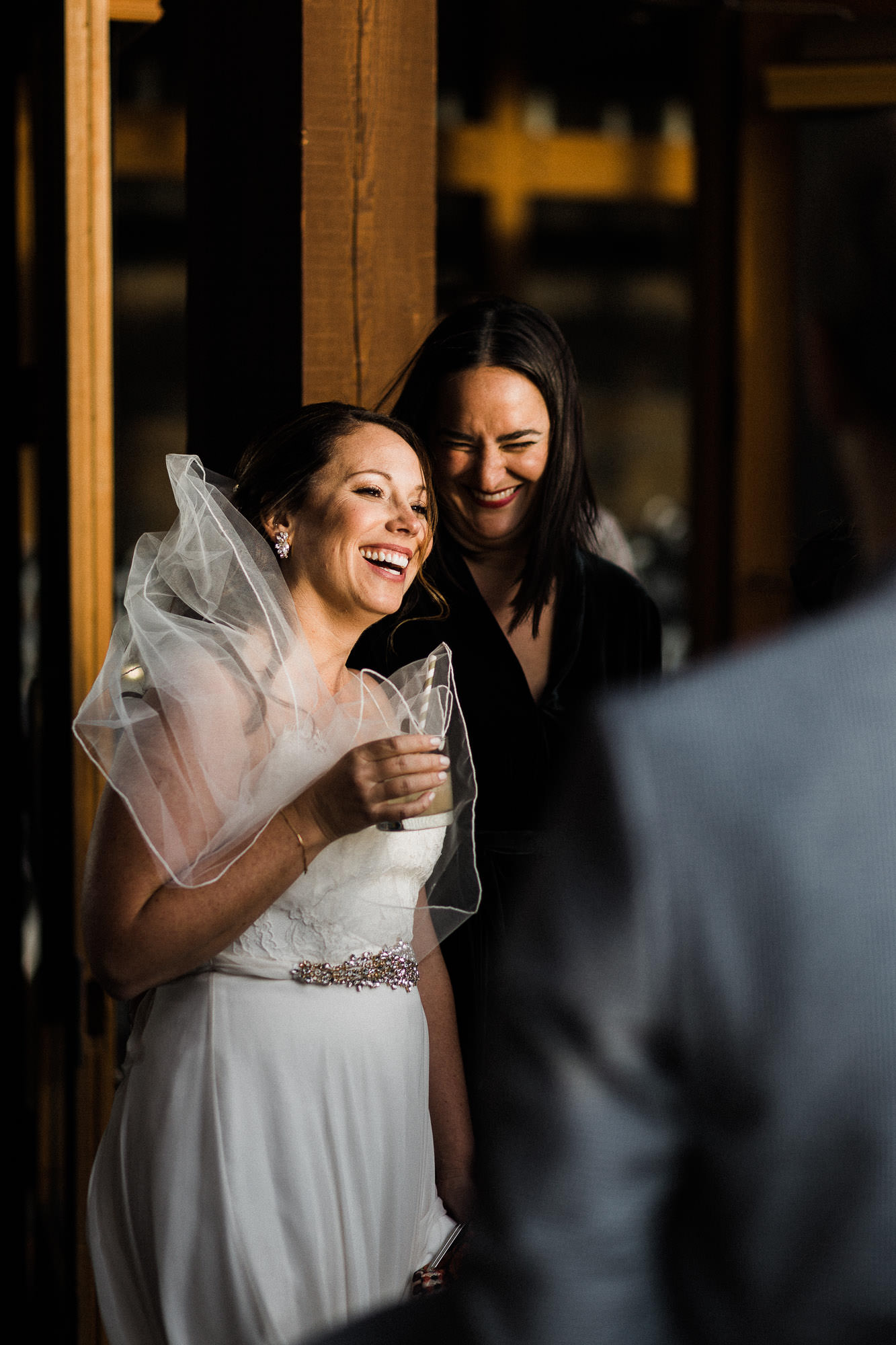 Bride and guest laugh at wedding reception at Broken Top Club in Bend, Oregon