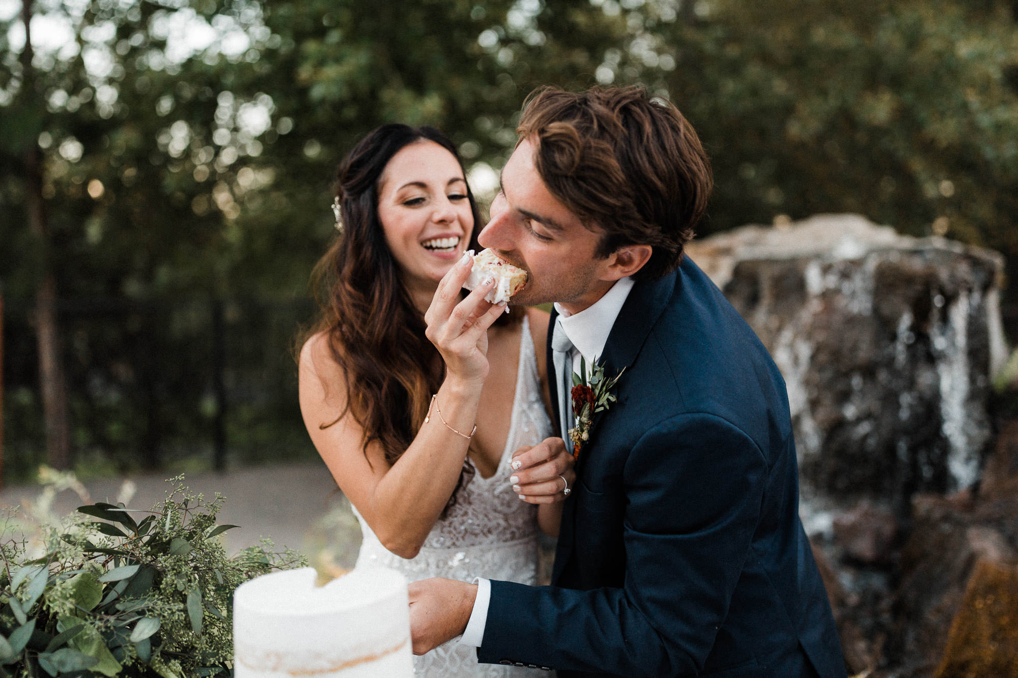 Bride feeds cake to groom at Broken Top Club in Oregon