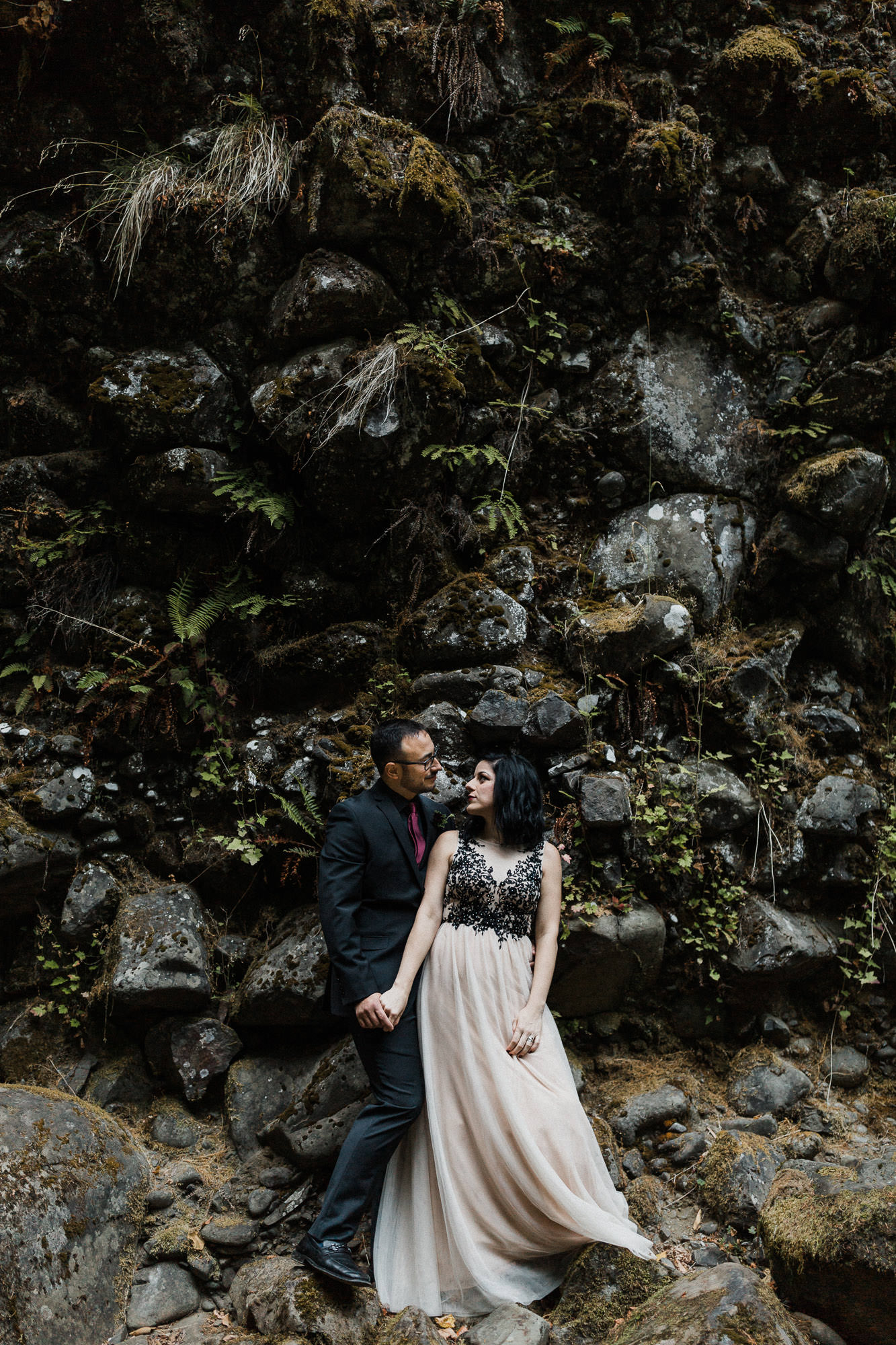 Bride and groom hold hands at Abiqua Falls, Oregon