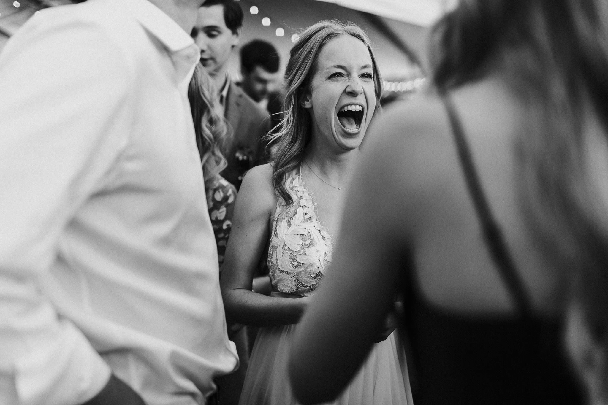 Bride laughs at wedding reception at Lewis and Clark College in Portland