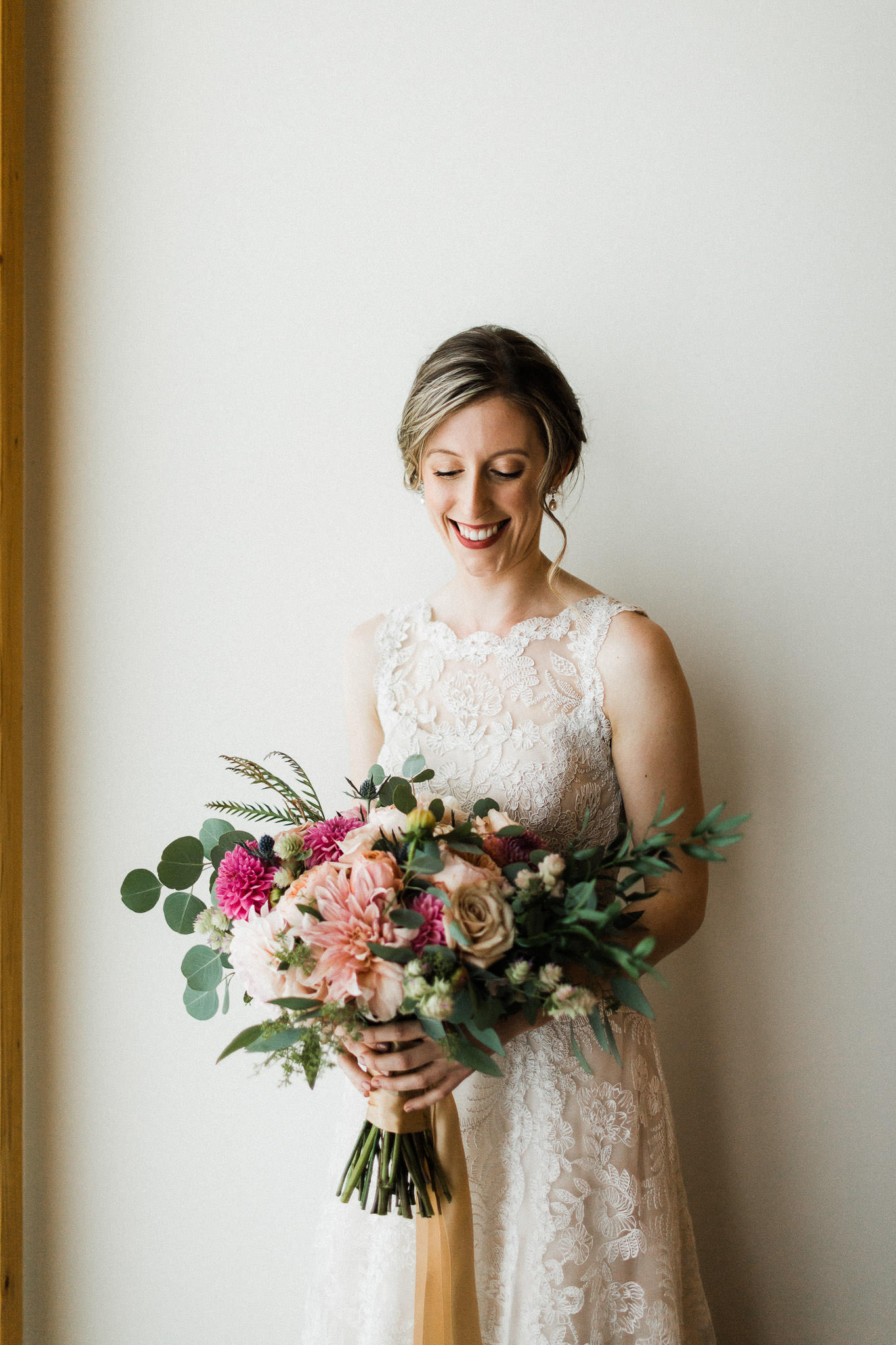 A bride smiles and holds bouquet at Nordia House in Portland Oregon