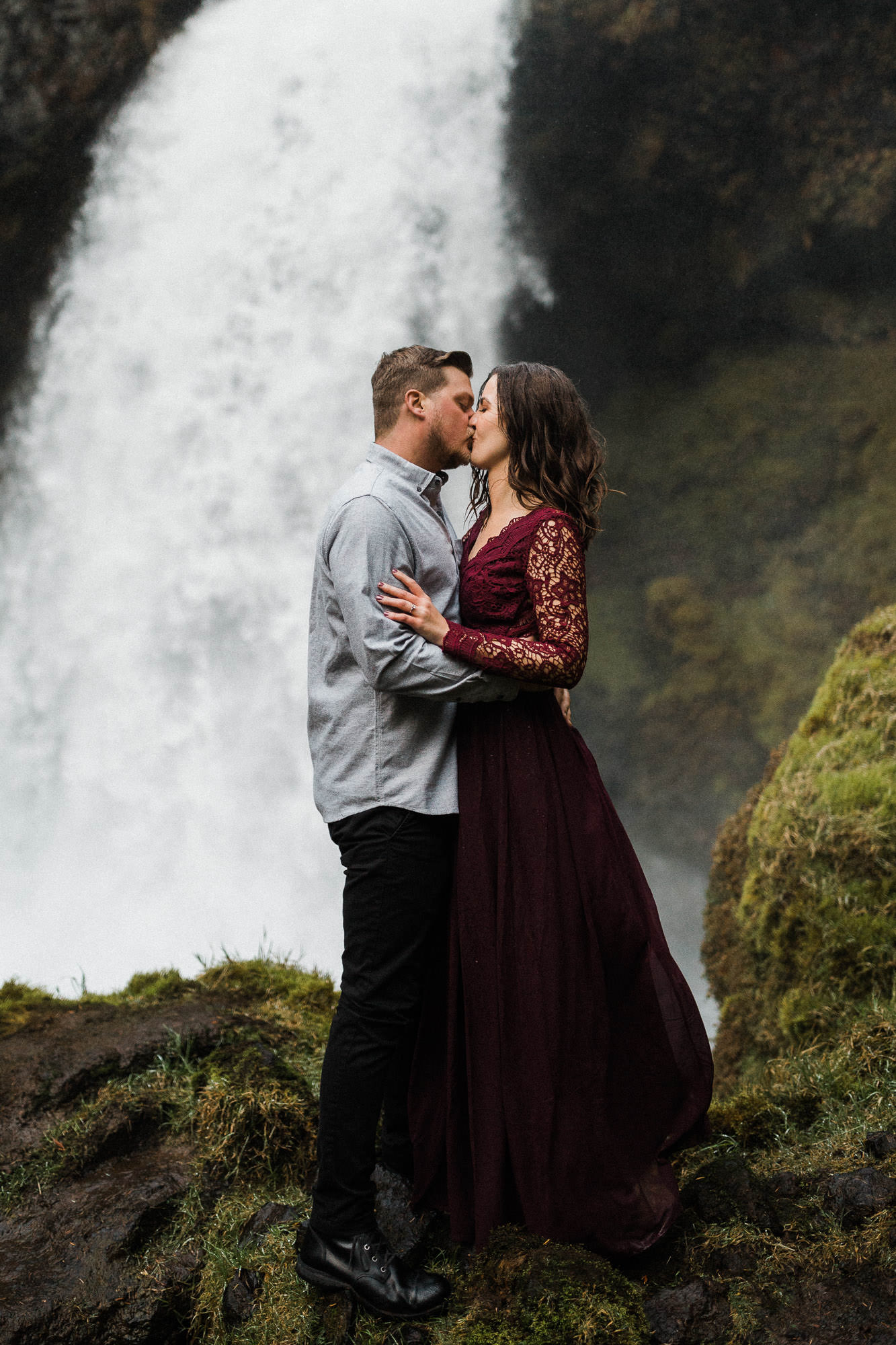 Couple kiss in front of Sahalie Falls in Oregon