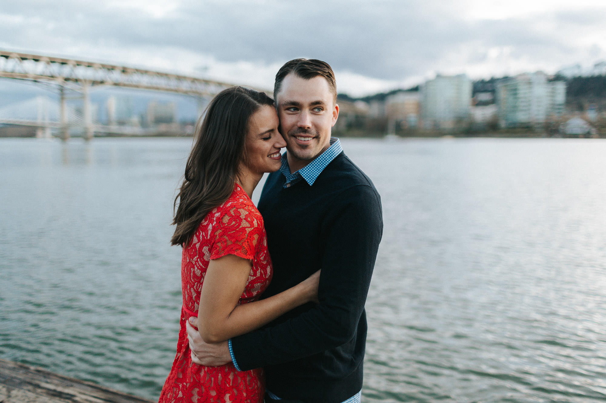 A couple embraces on the waterfront of Portland, oregon