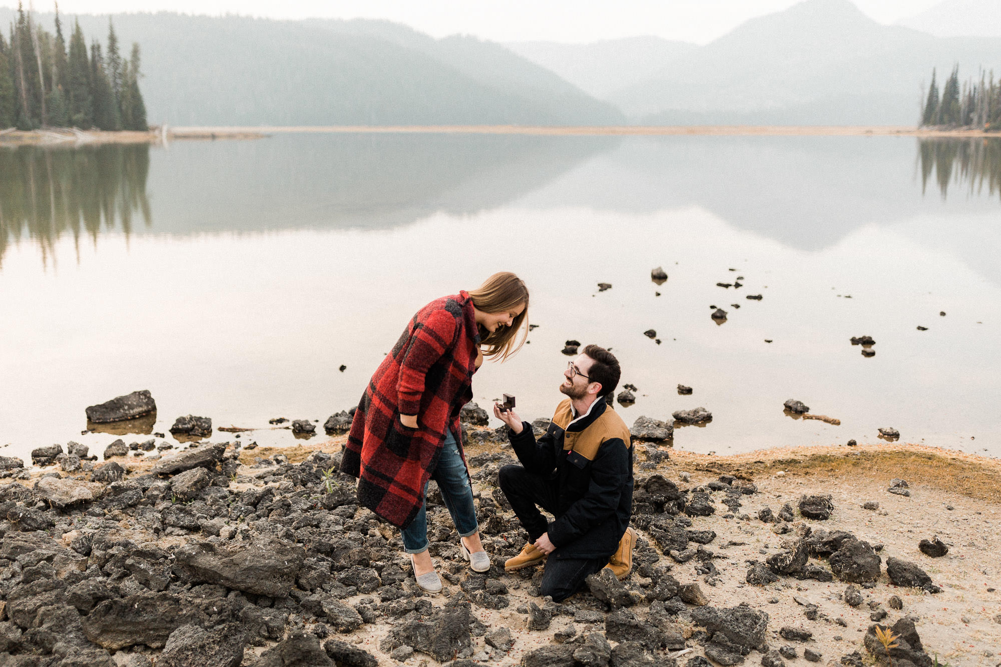 A man proposes to a woman on the shores of Sparks Lake, Oregon