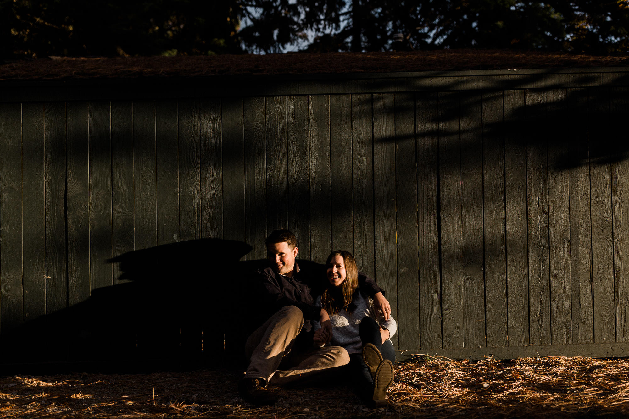 A couple sitting in front of a wall are dramatically lit at Suttle Lake in Oregon