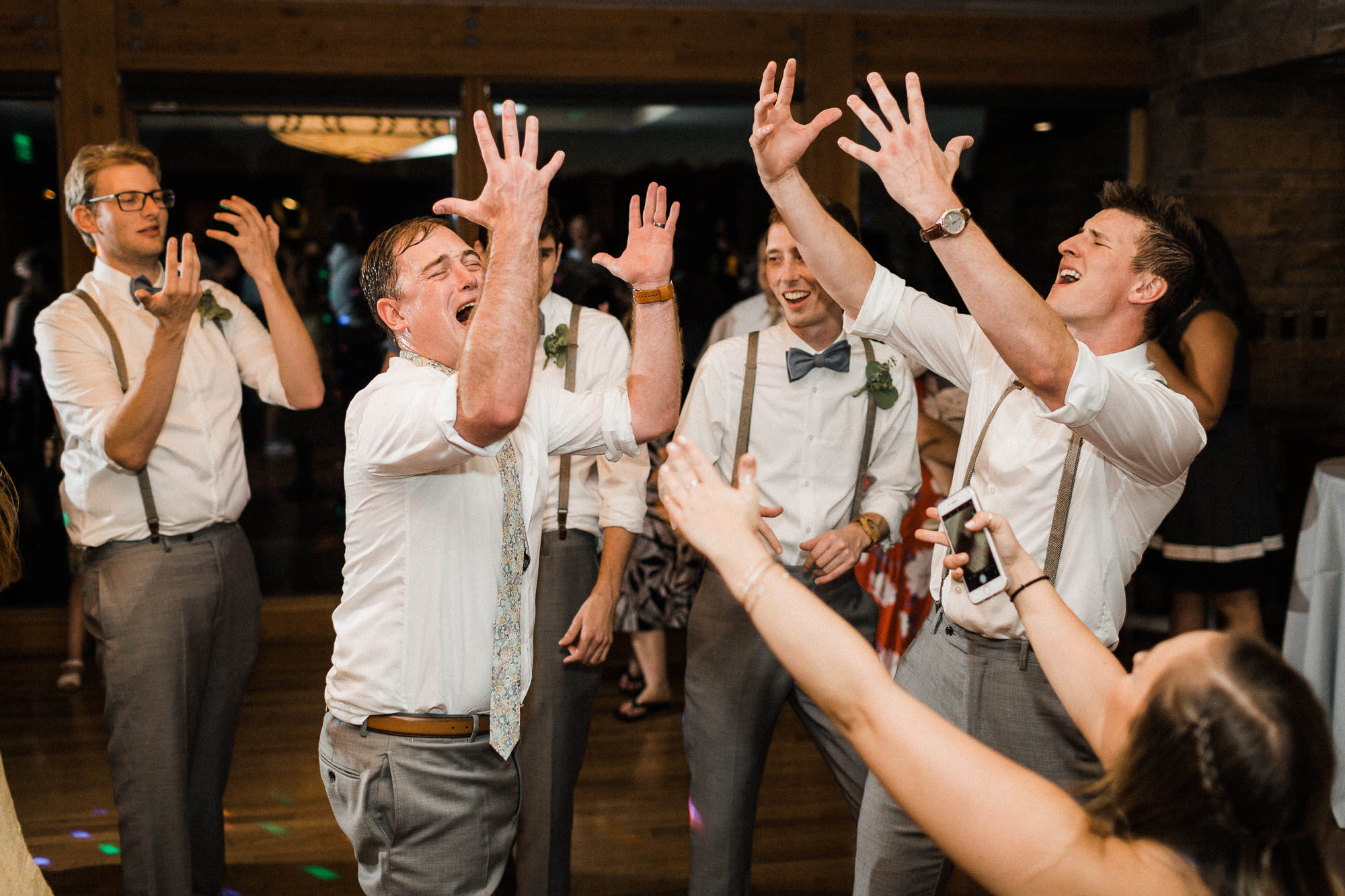 Groom and groomsmen dance at wedding at Broken Top Club in Bend, Oregon