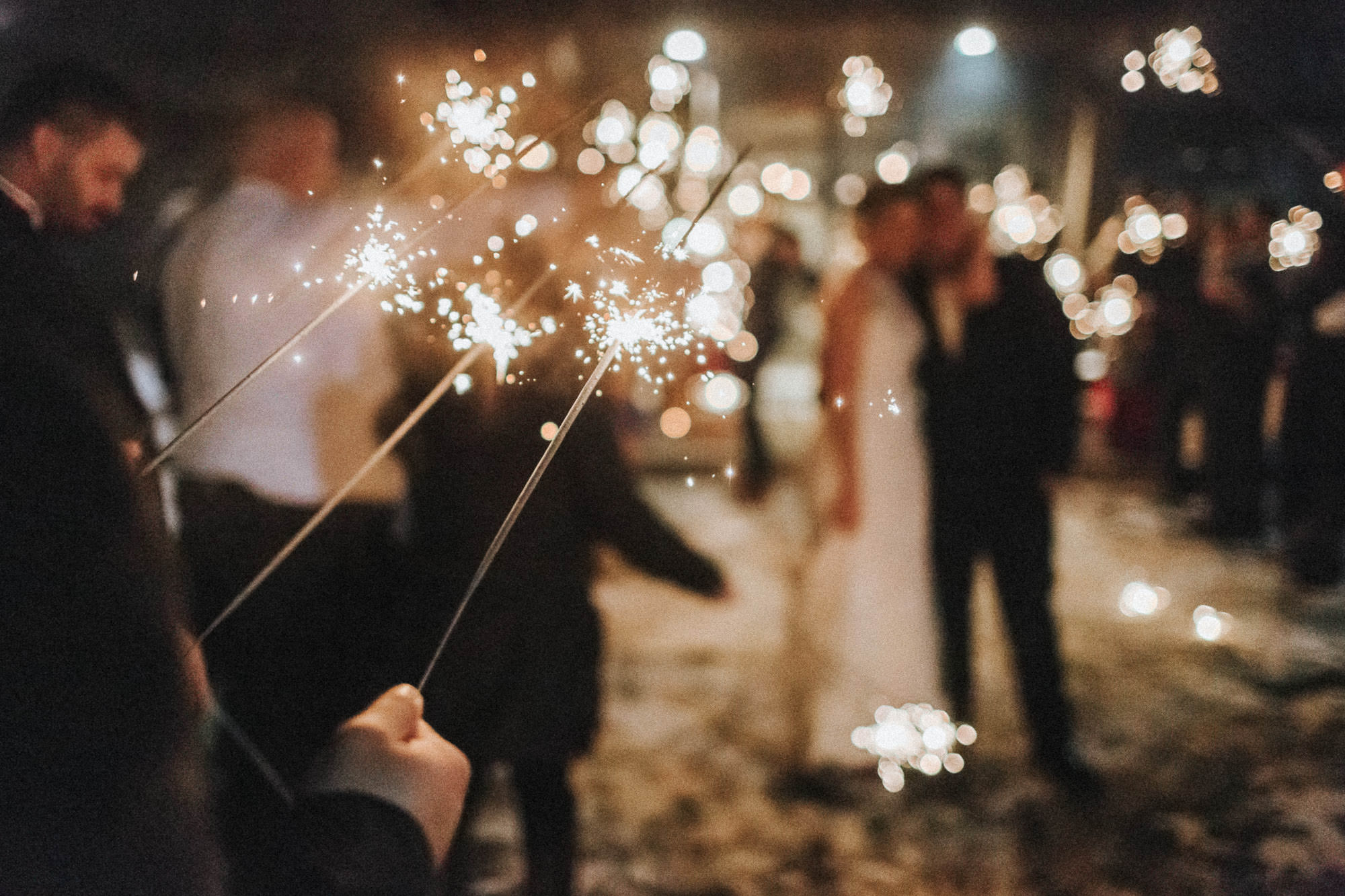 Wedding guests hold sparklers around bride and groom at Tetherow in Bend, Oregon