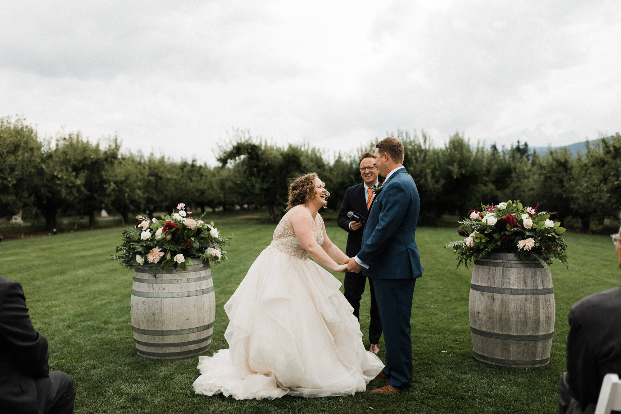 Bride and groom laugh during ceremony at Mt View Orchards in Hood River, Oregon