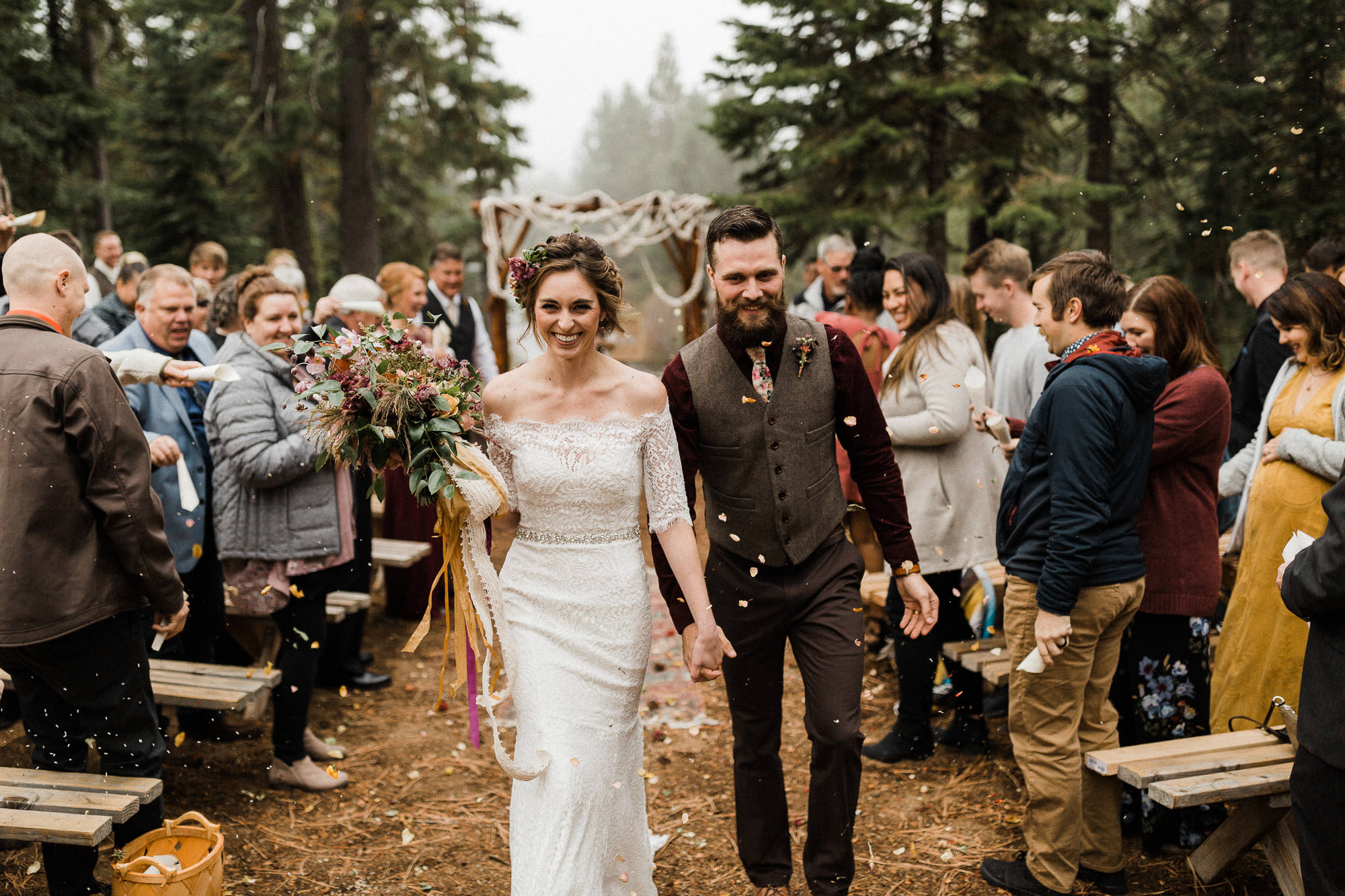 Bride and groom smile while walking down the aisle after wedding at Skyliner Lodge in Bend, Oregon