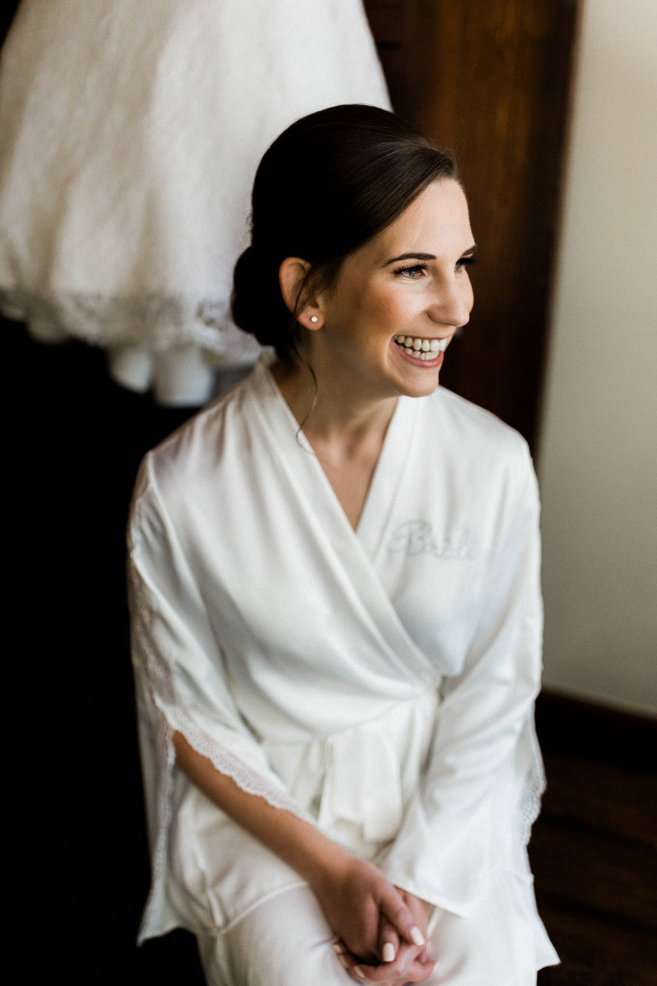 Bride smiles while wearing "bride" robe at Black Butte Ranch Oregon