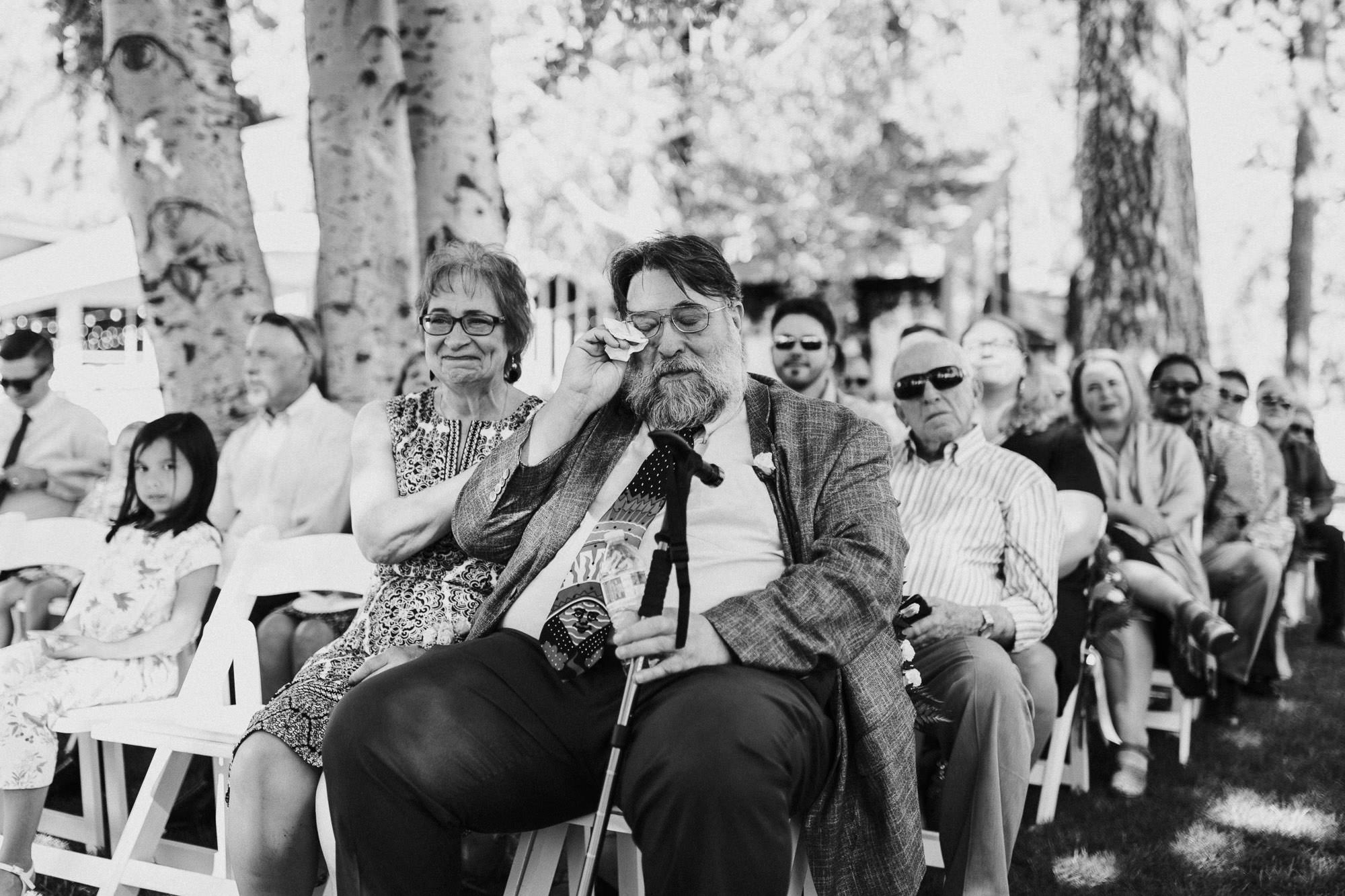 Father of the groom cries during wedding ceremony at Black Butte Ranch in Oregon