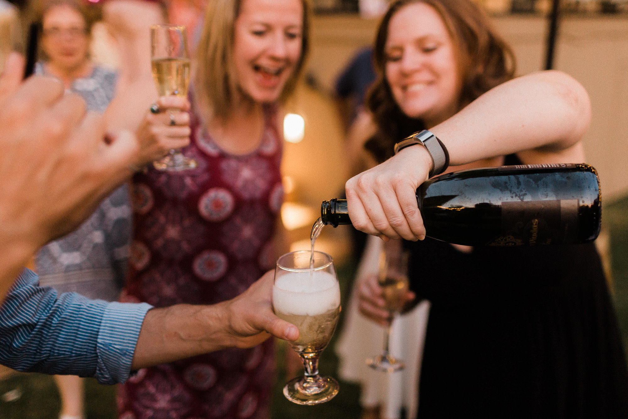 Guests pour champagne at a wedding reception at Black Butte Ranch