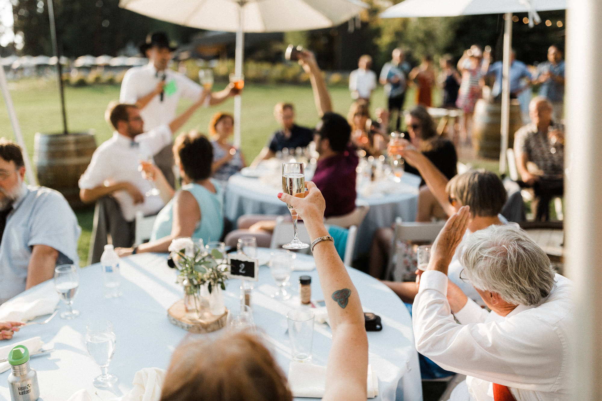 Guests lift their glasses during toasts at a Black Butte Ranch wedding