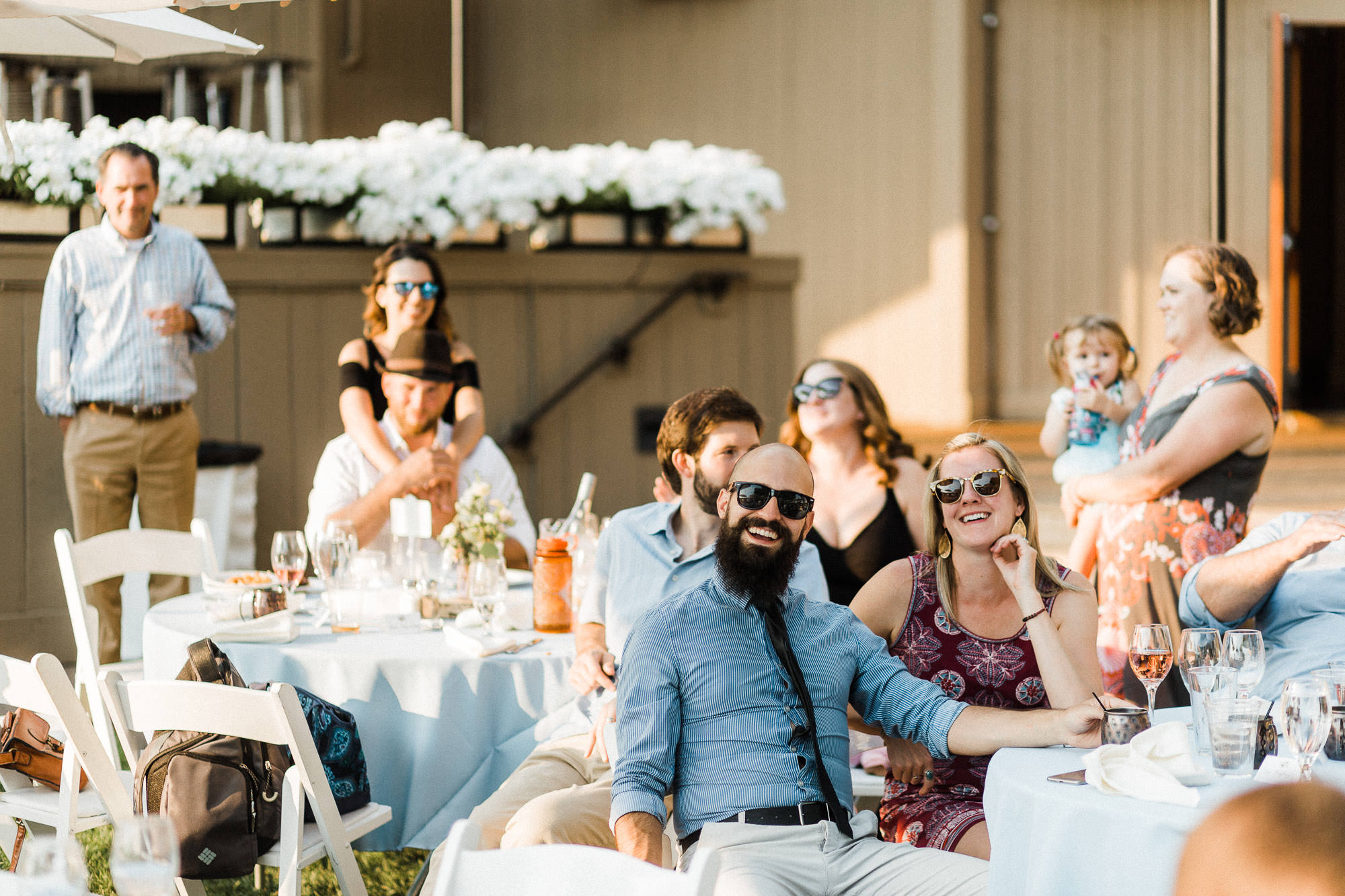 Guests listen to toasts at a wedding reception at Black Butte Ranch in Oregon