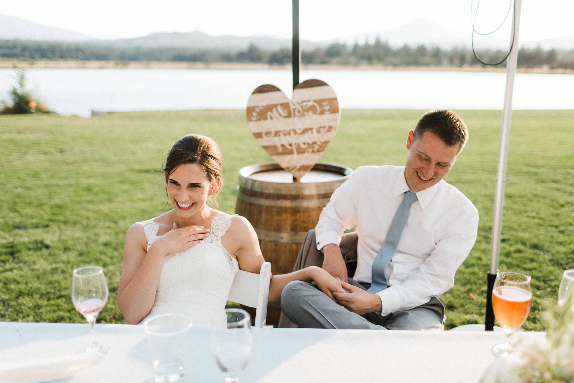 Bride and groom laugh while listening to toasts at Black Butte Ranch