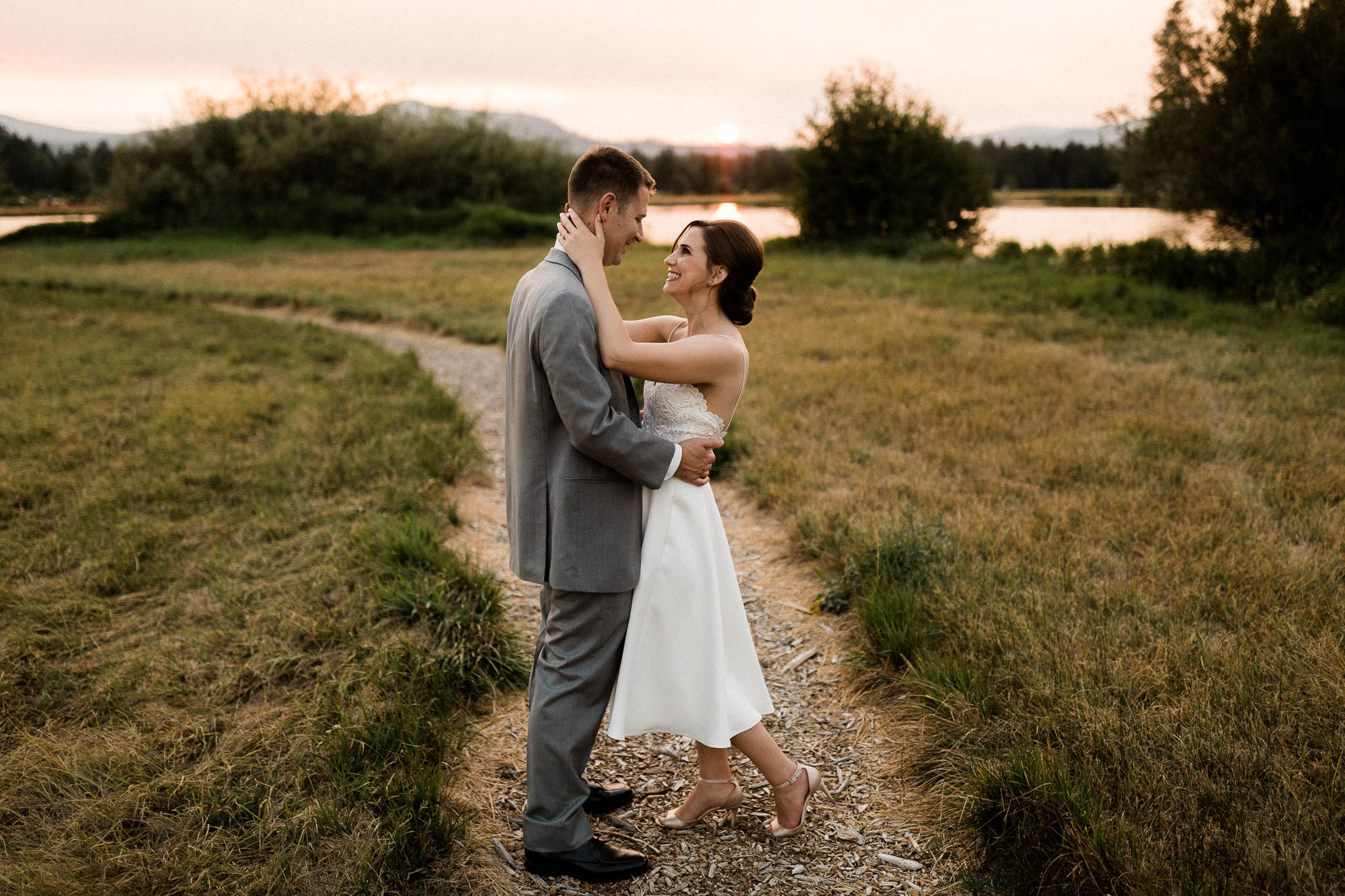 Bride and groom pose on a trail during sunset at Black Butte Ranch 