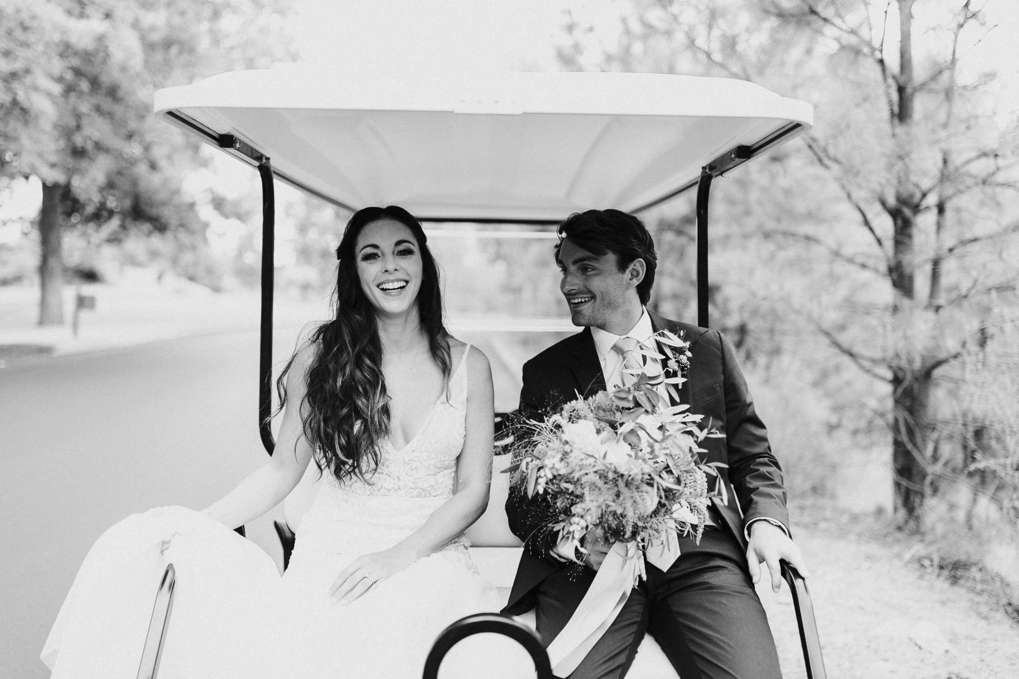 Bride and groom sit in back of golf cart at Broken Top Club in Bend, Oregon
