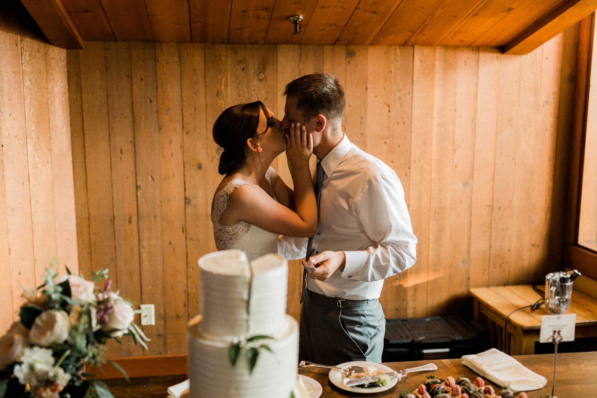Bride and groom kiss after cake cutting at Black Butte Ranch