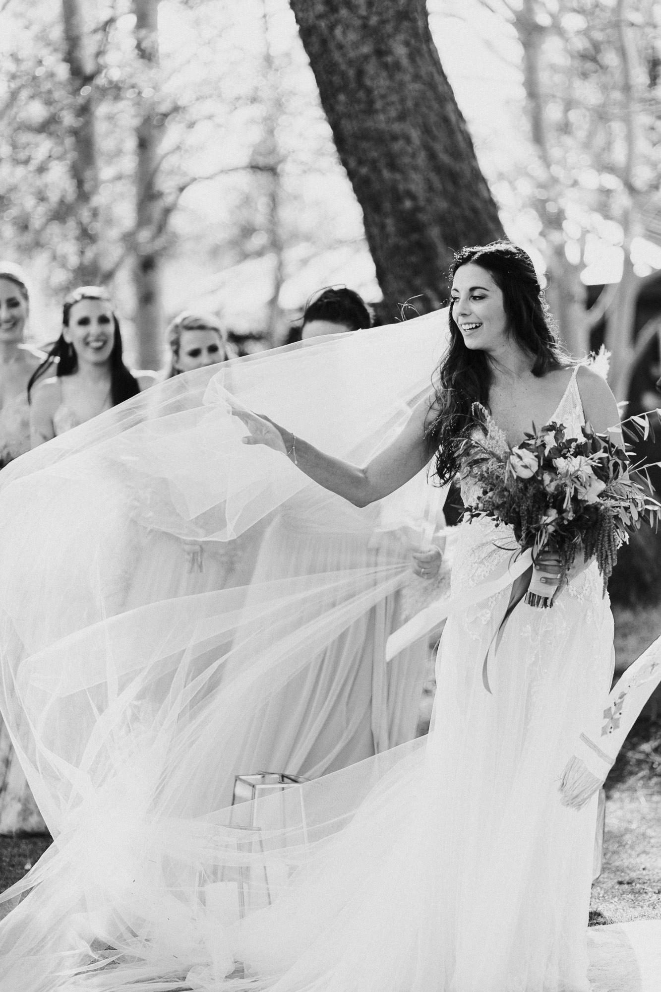 Wind blows bride's veil during wedding ceremony at Broken Top Club in Bend, Oregon