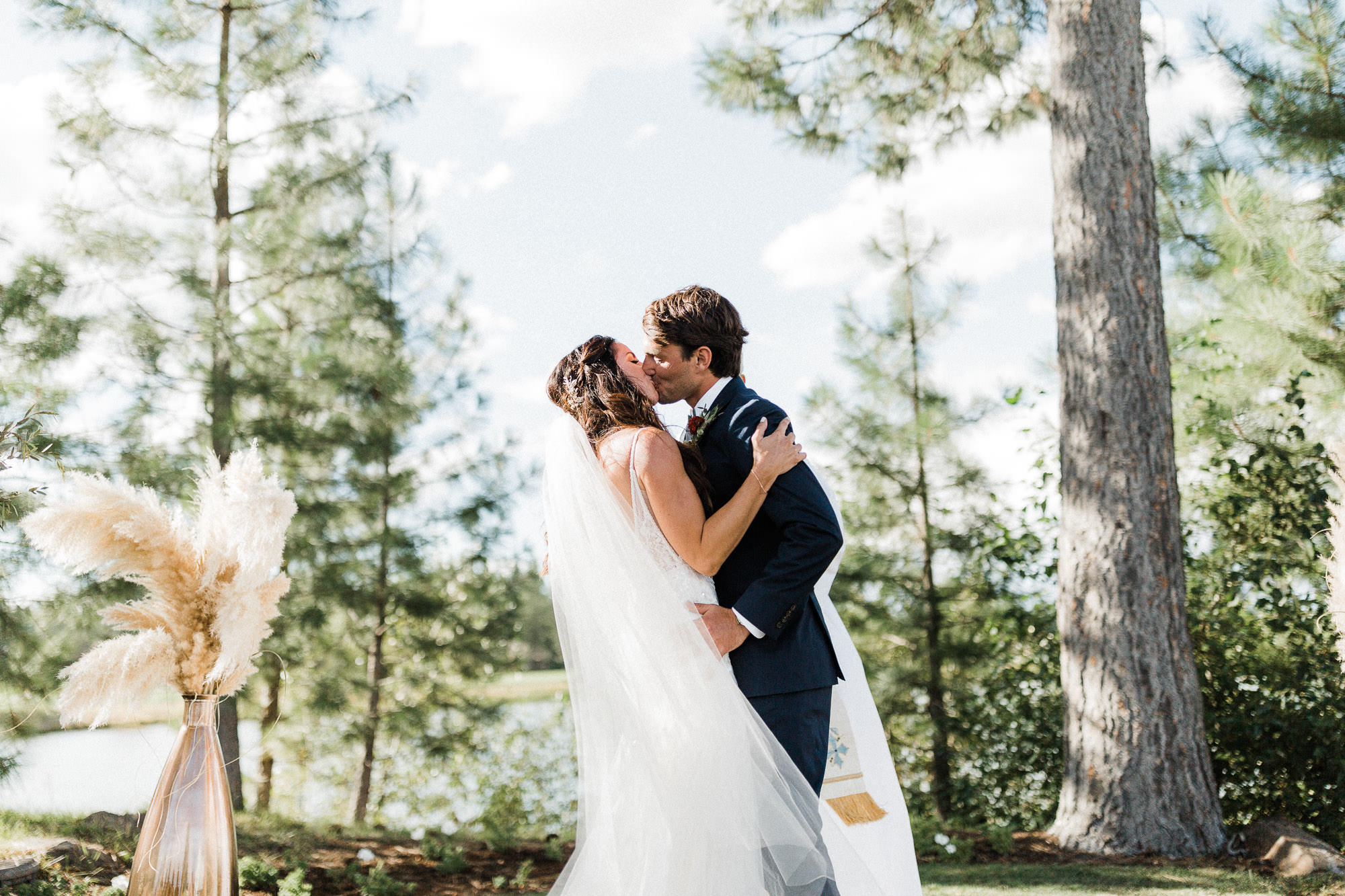 Bride and groom share first kiss at wedding at Broken Top Club in Bend, Oregon