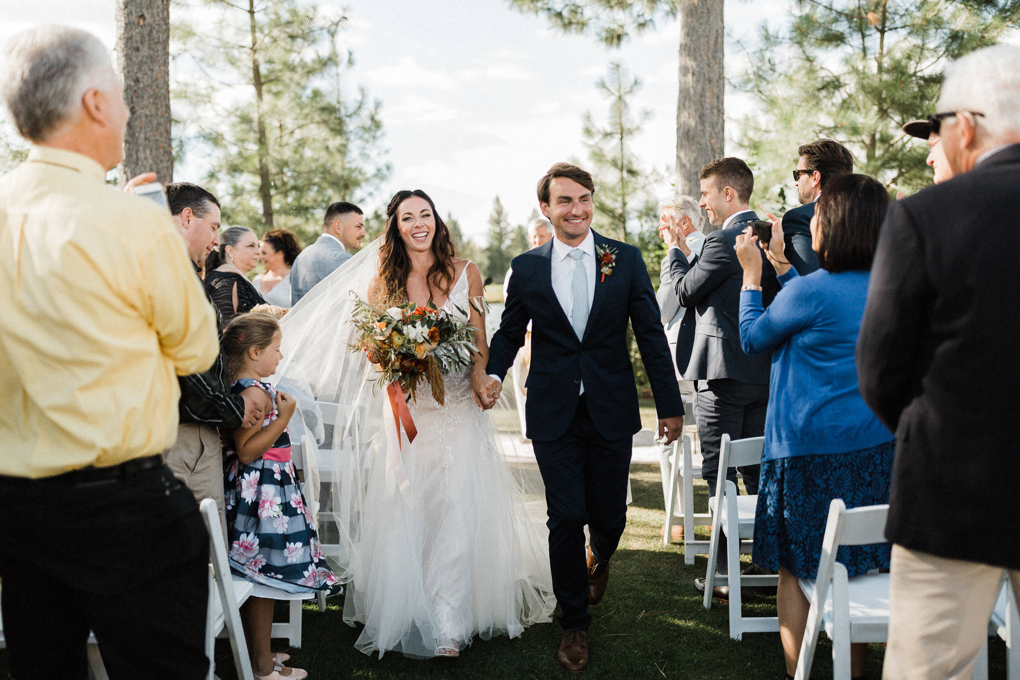 Bride and groom walk down the aisle after ceremony at Broken Top Club in Bend, Oregon