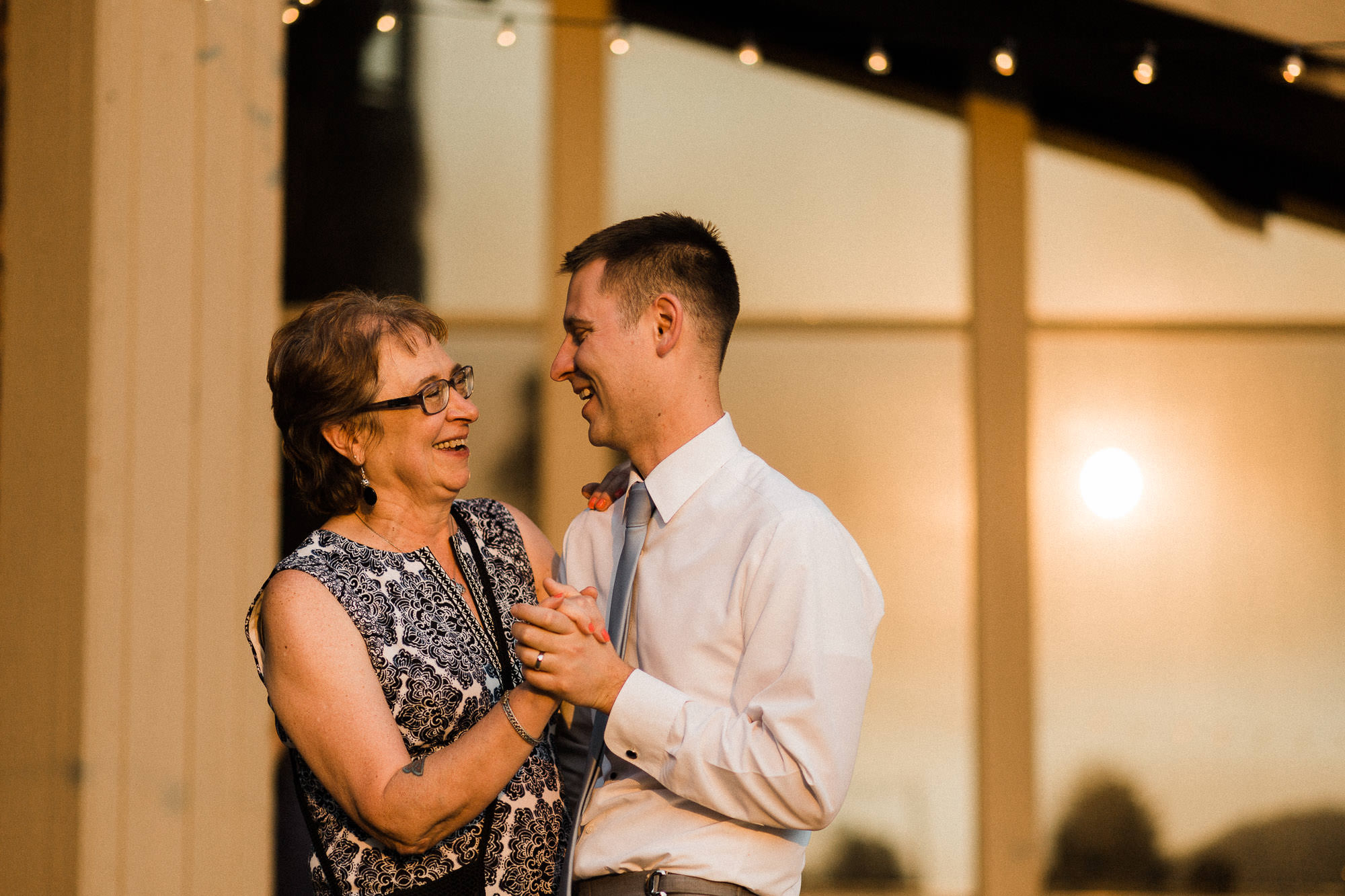 Groom and mother dance during wedding reception at Black Butte Ranch in Oregon