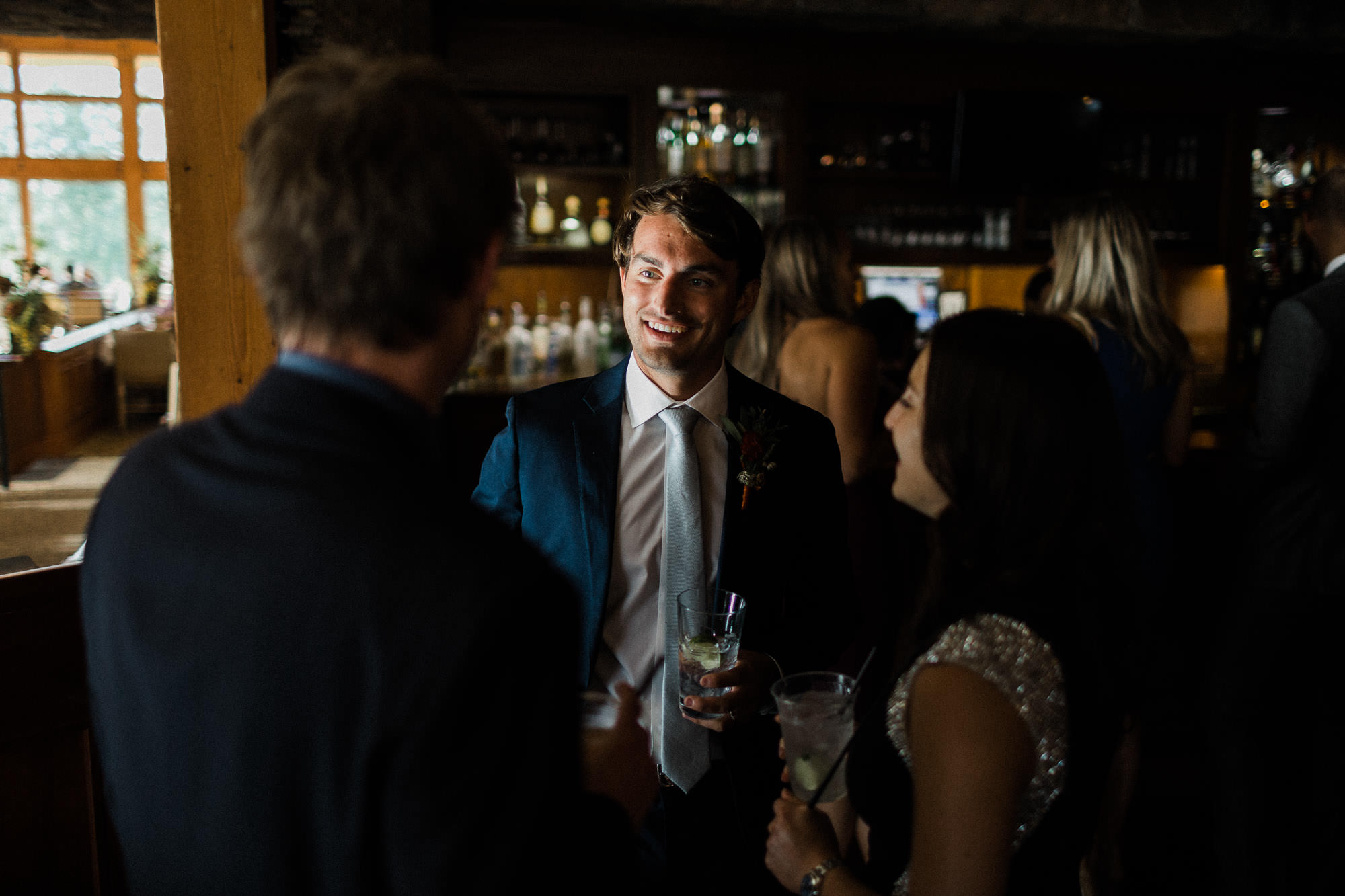 Groom chats with guests at Broken Top Club in Bend, Oregon