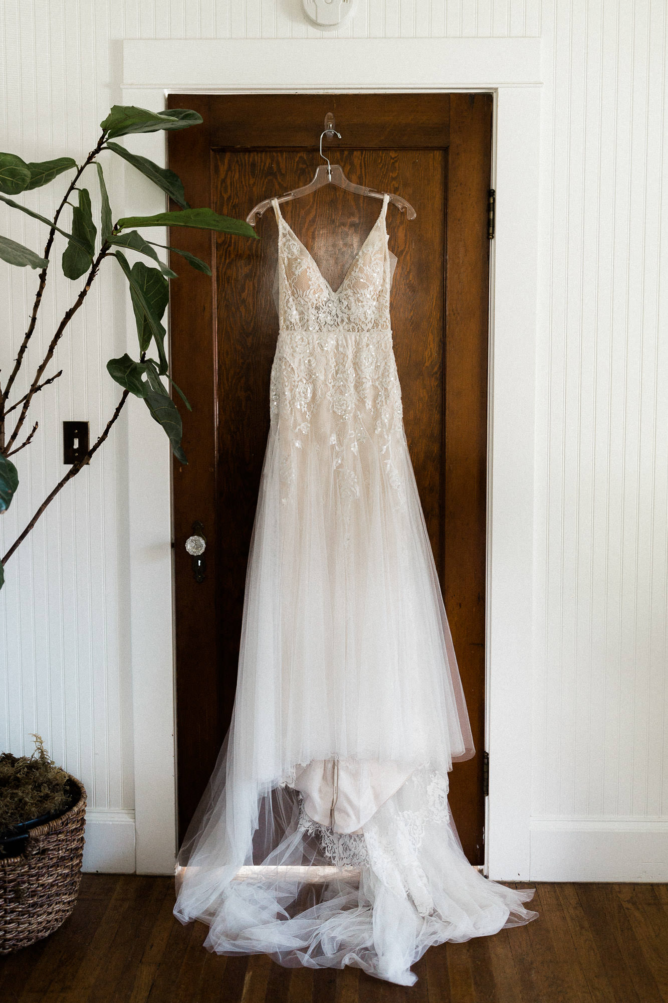 Wedding dress hanging in front of door in a cottage in Bend, Oregon