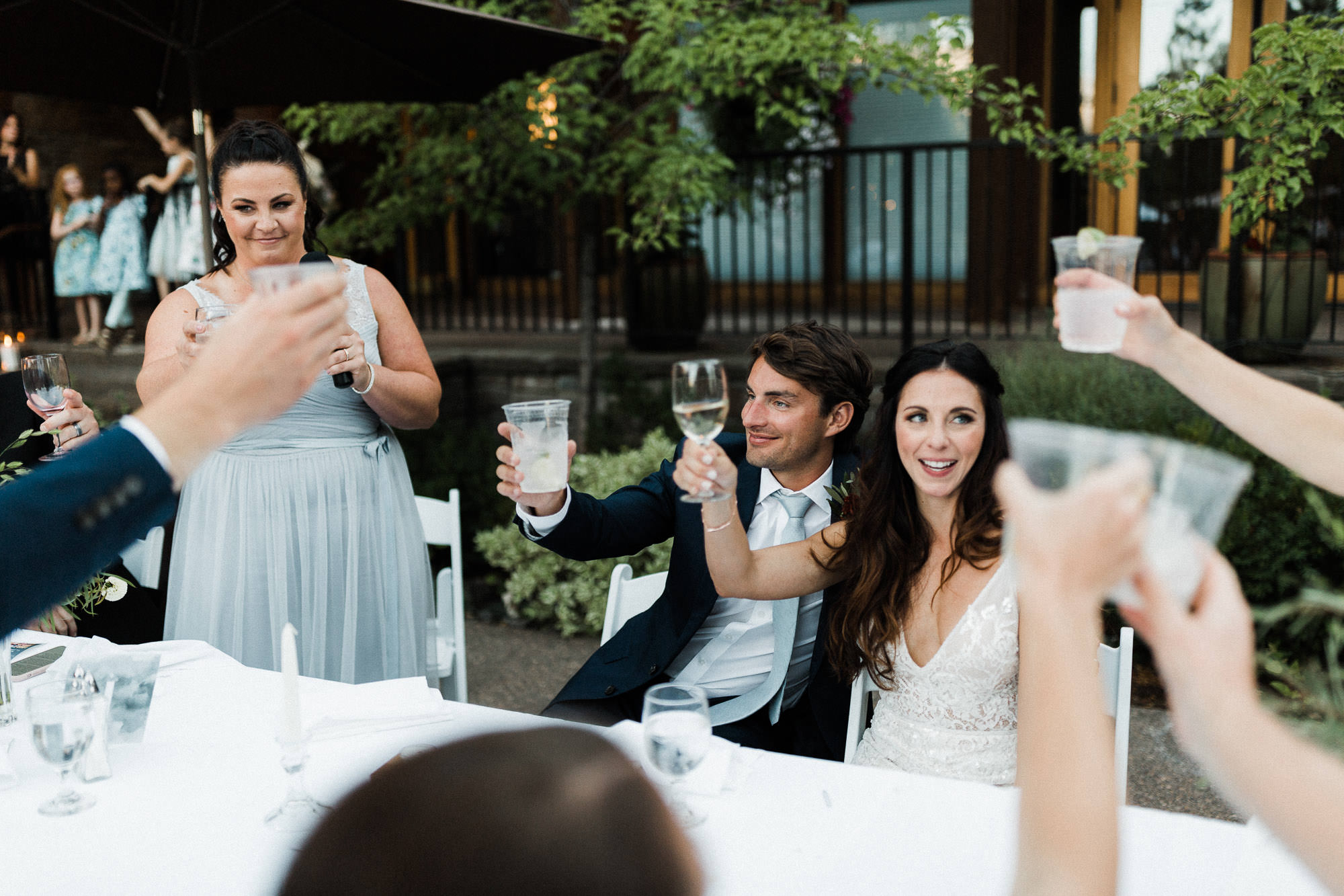 Bride and groom raise glasses in toast at Broken Top Club in Bend, Oregon
