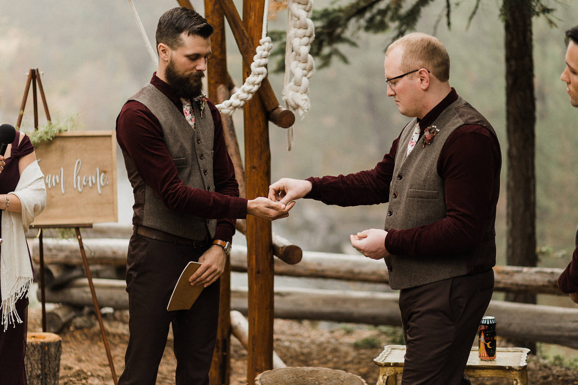 Best man hands groom a ring during ceremony at Skyliner Lodge