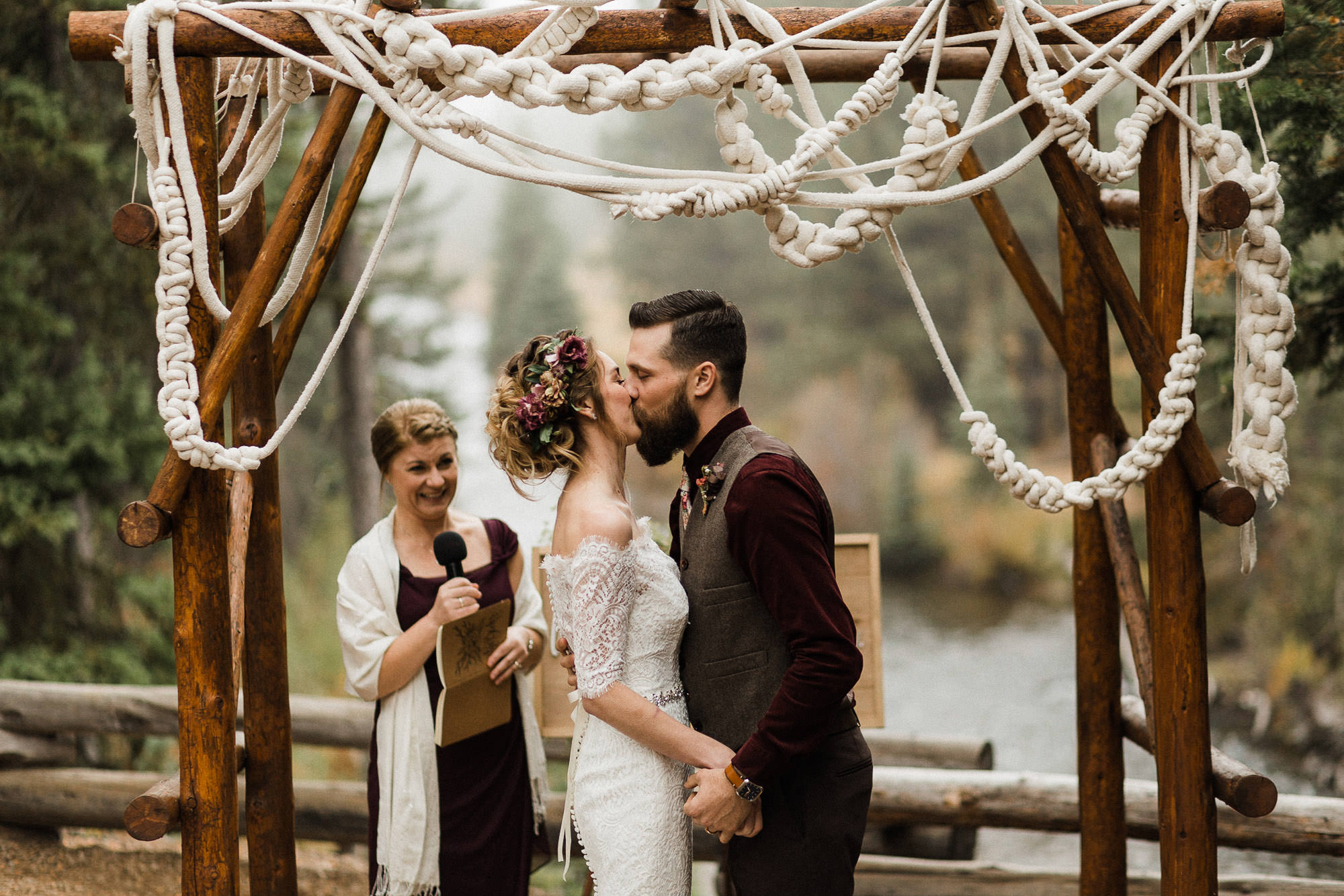 Bride and groom share their first kiss at Skyliner Lodge in Bend, Oregon
