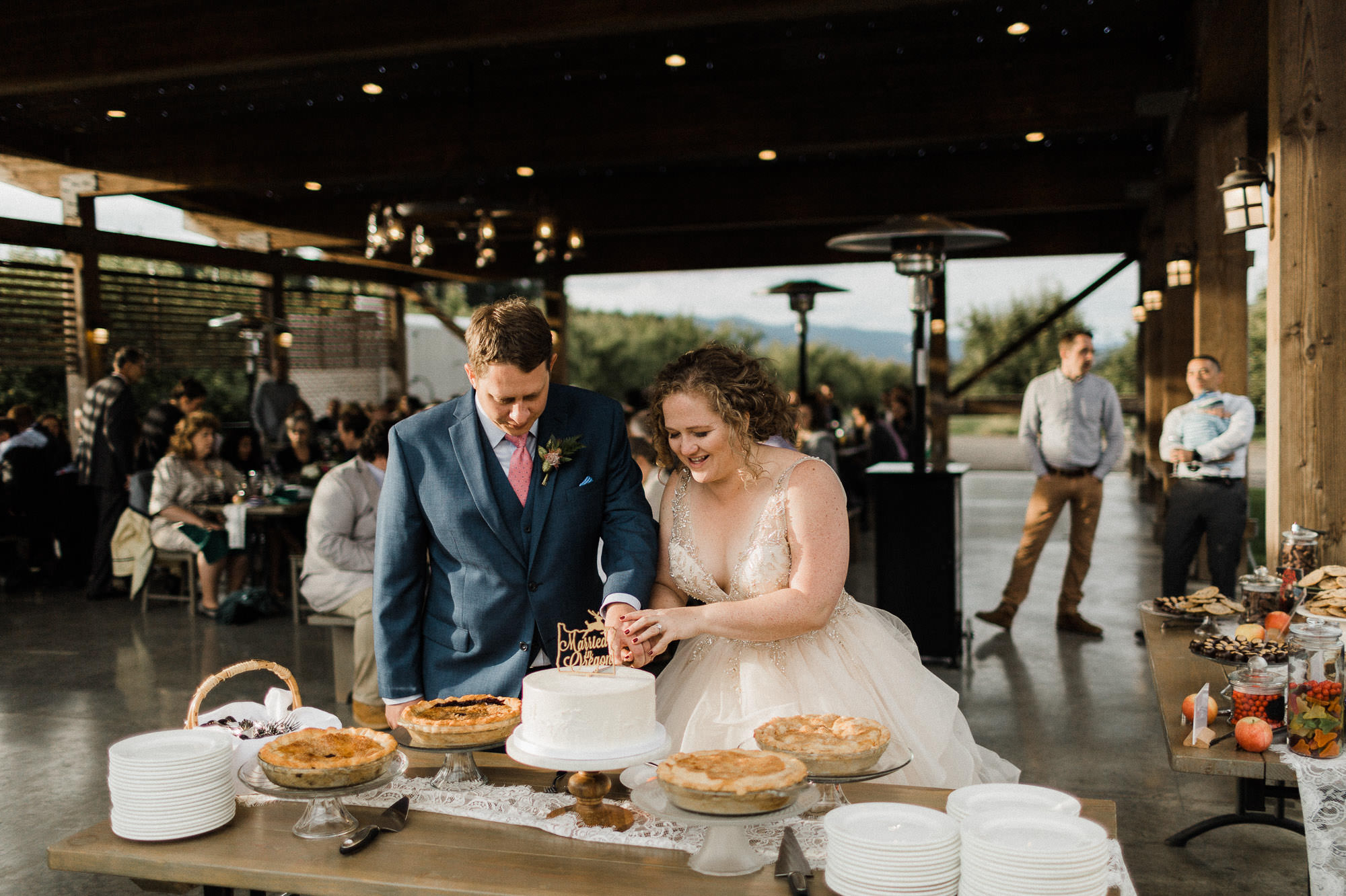 The bride and groom cut their cake at Mt. View Orchards in Mt Hood, Oregon.
