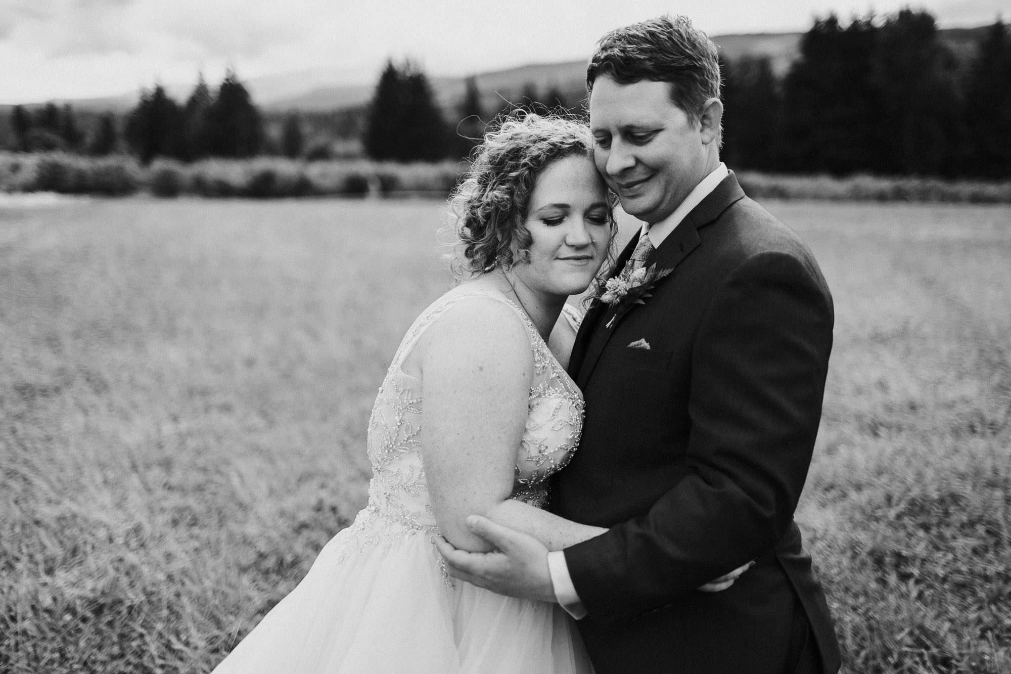 The bride and groom embrace at Mt. View Orchards in Mt Hood, Oregon.