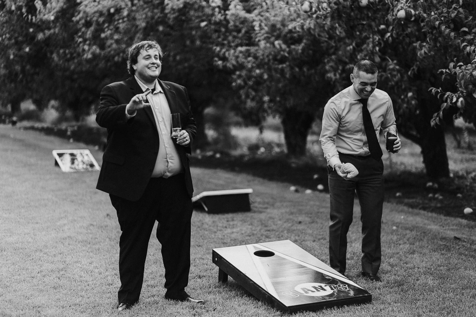 Wedding guests play corn hole at Mt. View Orchards in Mt Hood, Oregon.