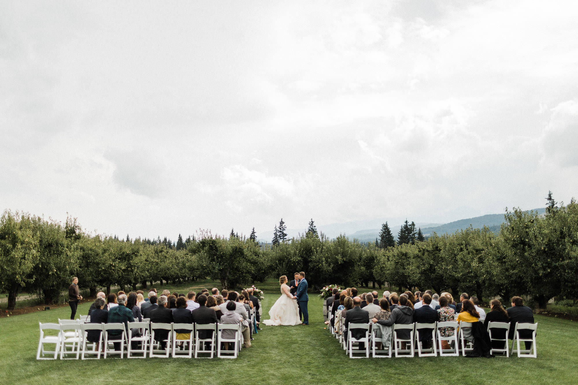 A wide shot shows the wedding ceremony and its surroundings at Mt. View Orchards.