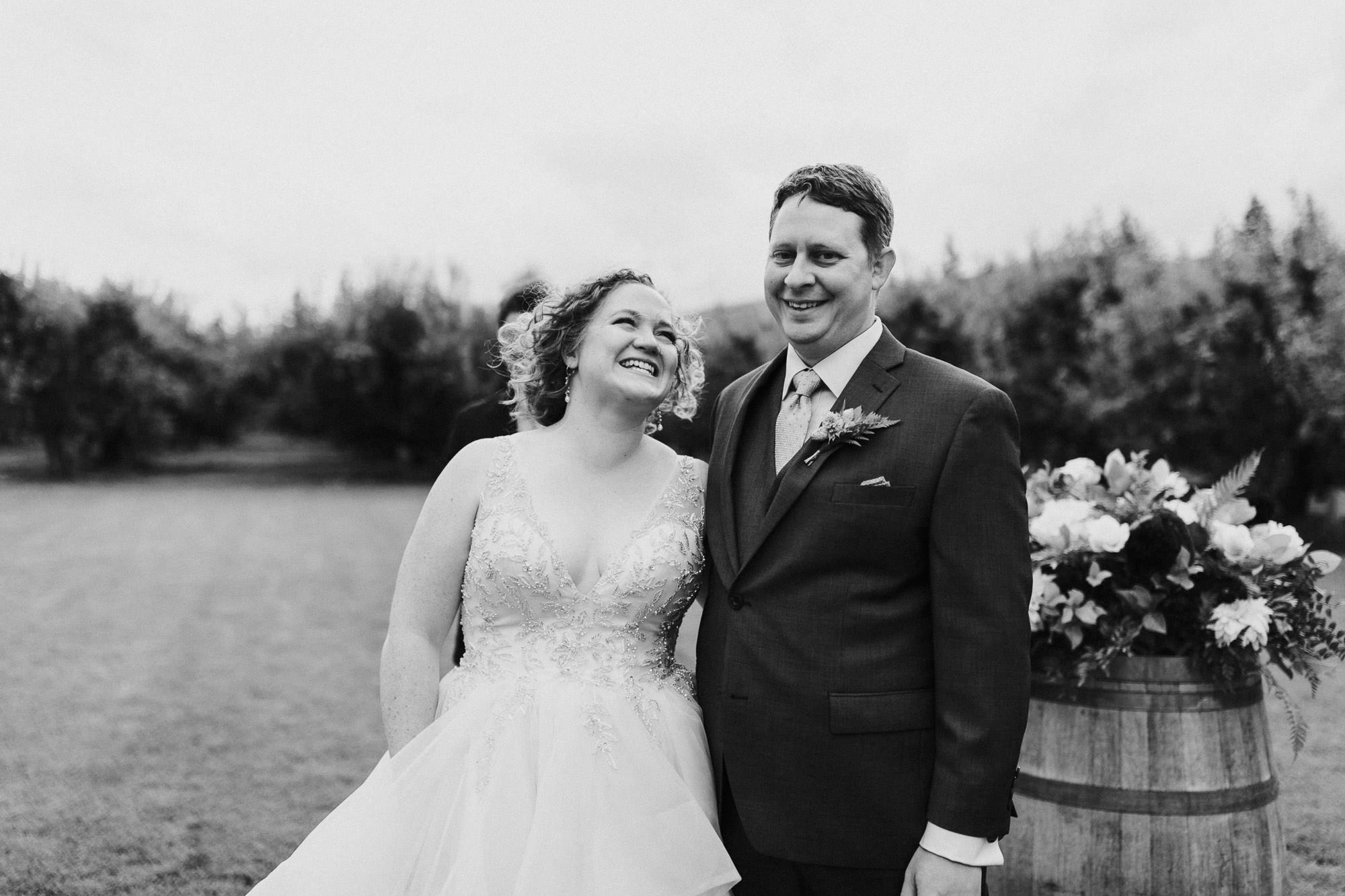 The bride and groom laugh during their wedding ceremony at Mt. View Orchards.