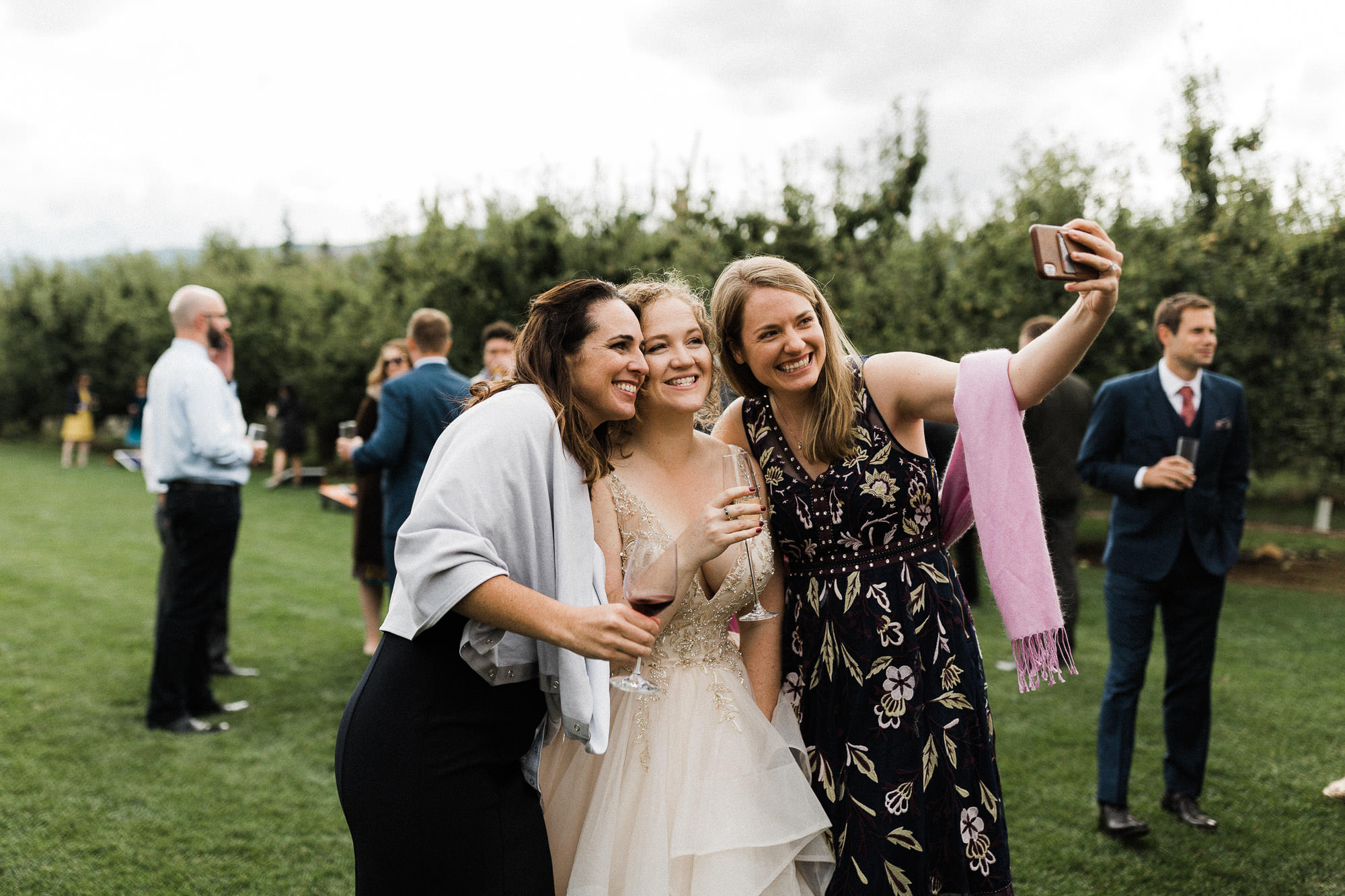 The bride takes selfies with guests at Mt. View Orchards.