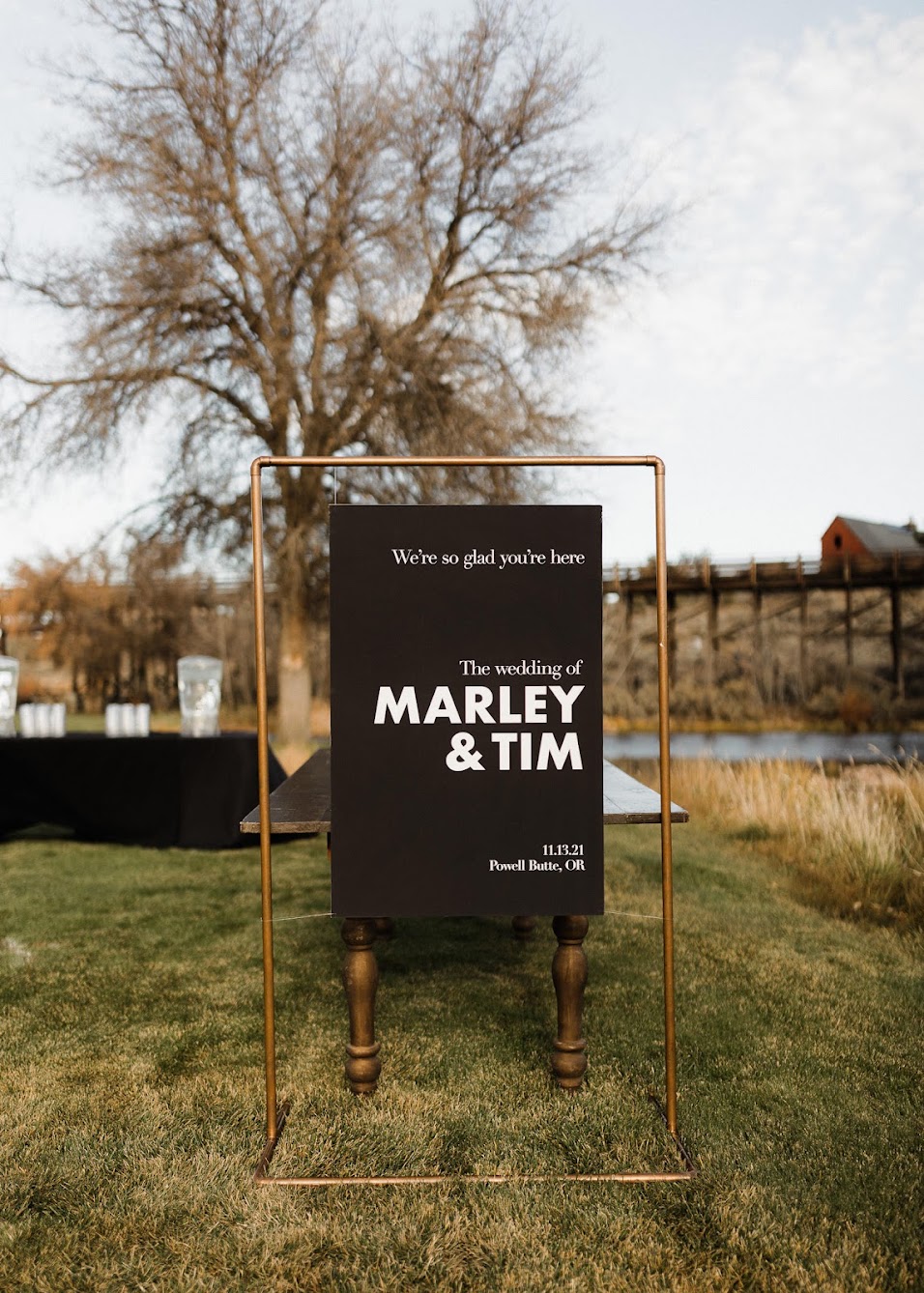A modern-looking wedding sign on a copper frame, clean lines with a big font size welcoming guests. 