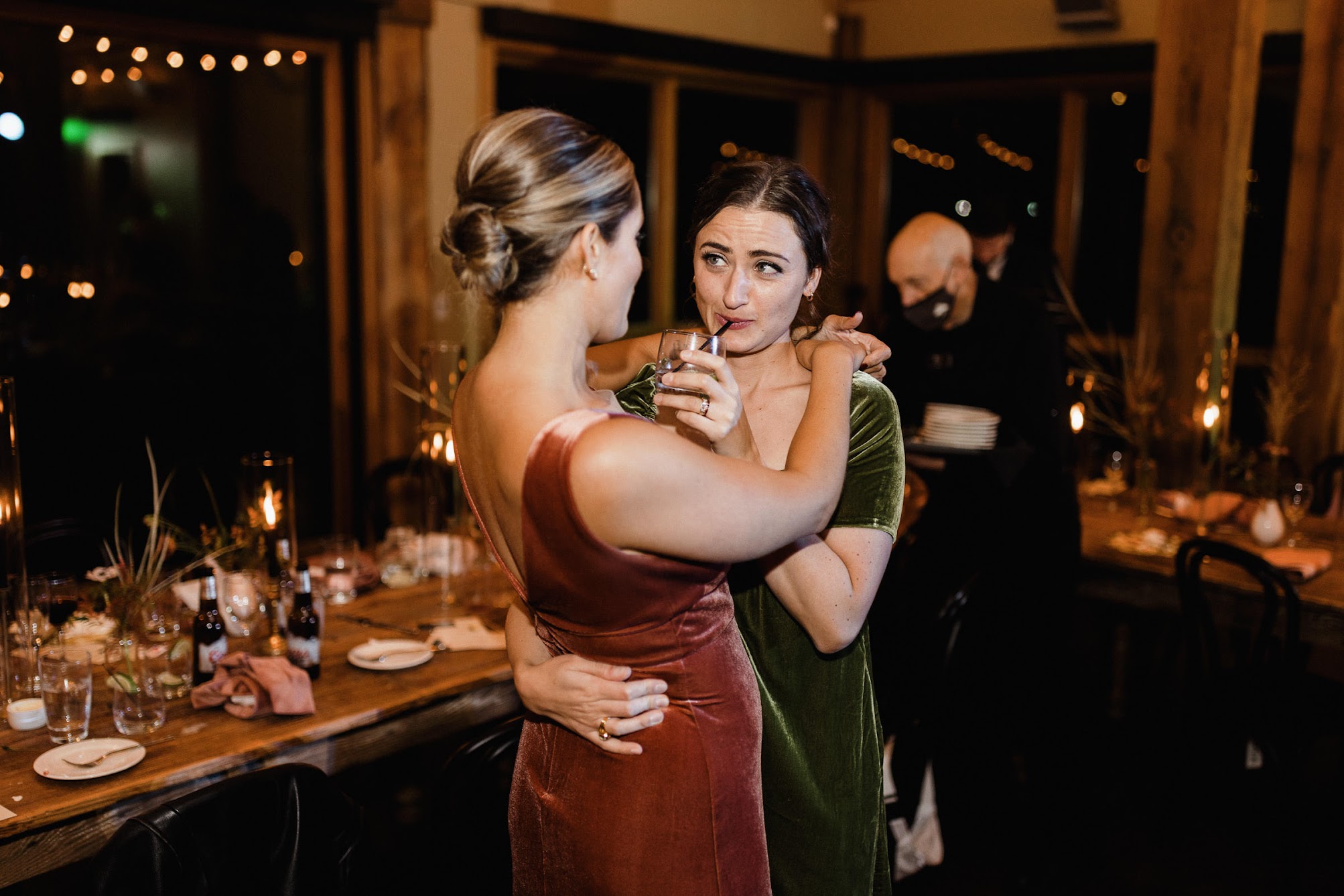 two bridesmaids hugging each other 
