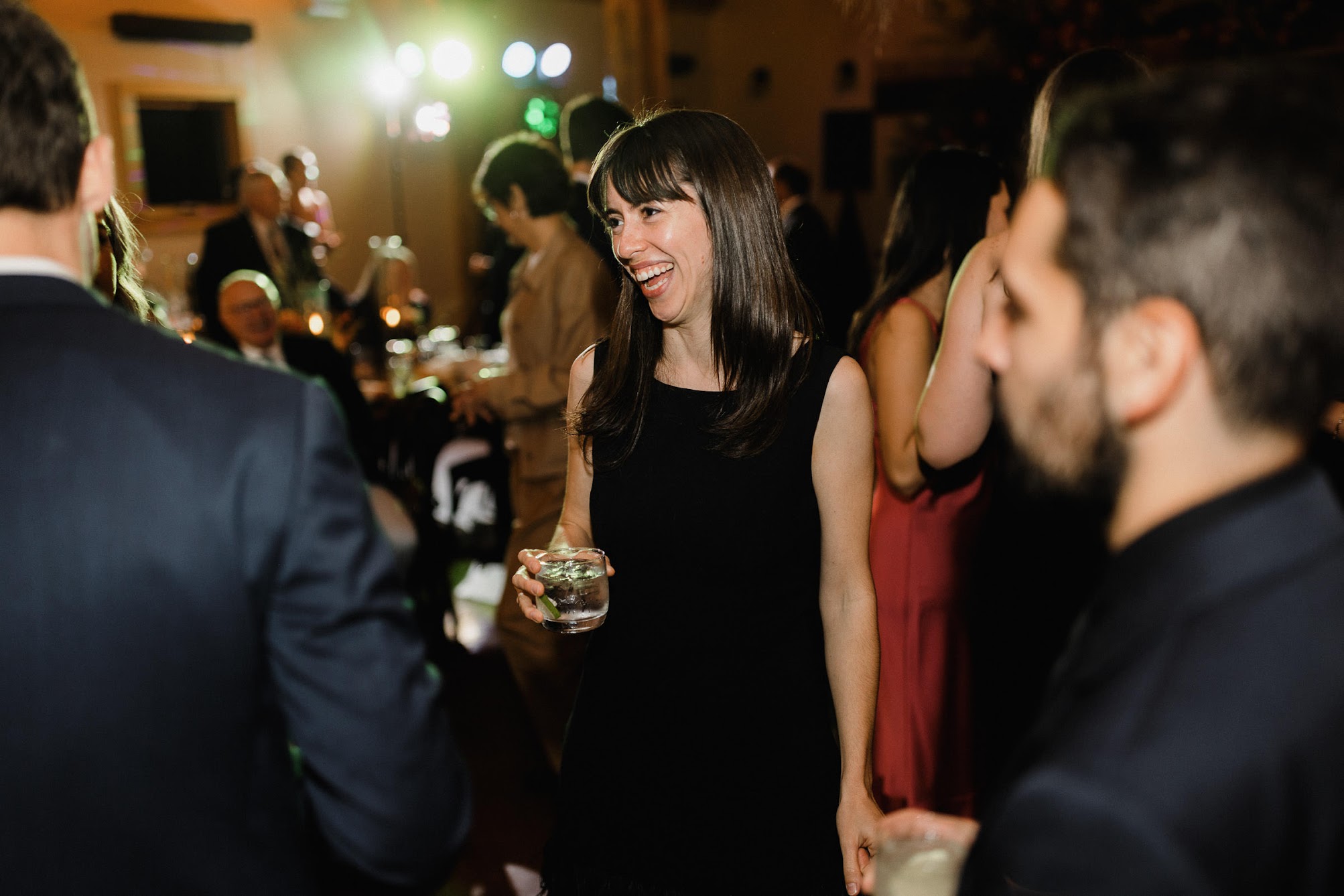a guests laughing while holding a drink