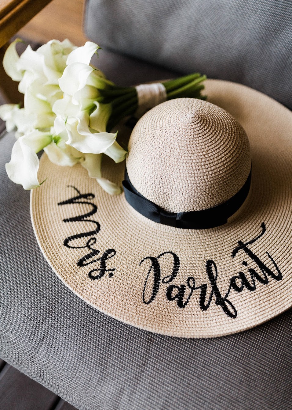 white floral bouquet, laying on a sun hat that says "Mrs. Parfait"