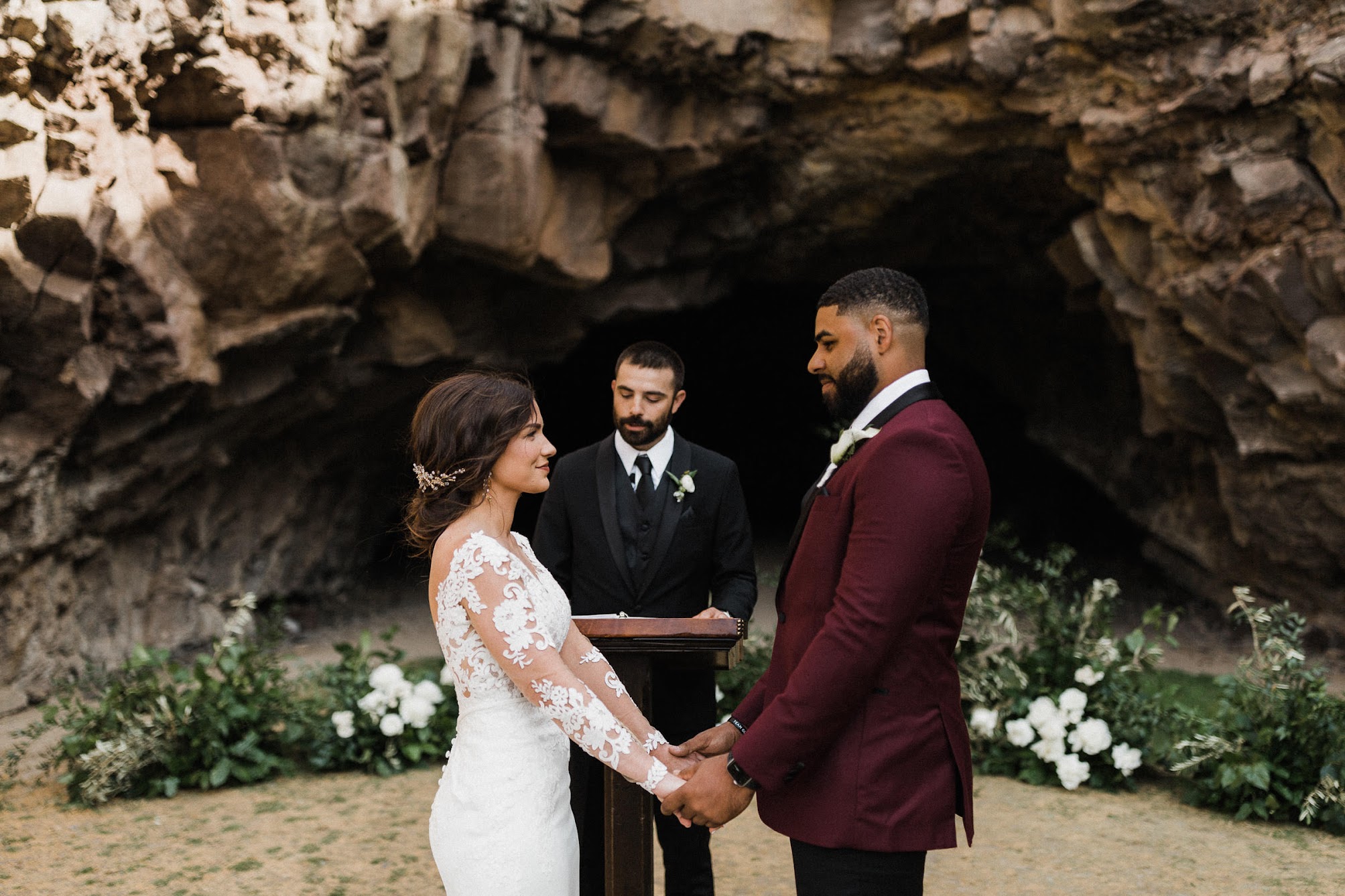 the couple looking deeply into each others eyes, while the officiant speaks to them