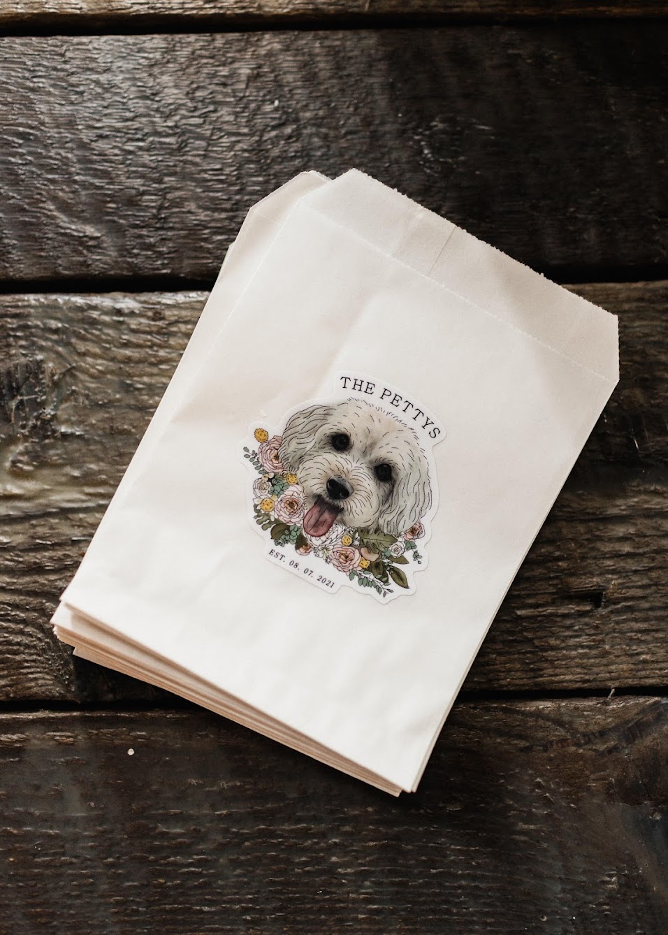 pastry bags with a picture of their dog on it surrounded by florals 