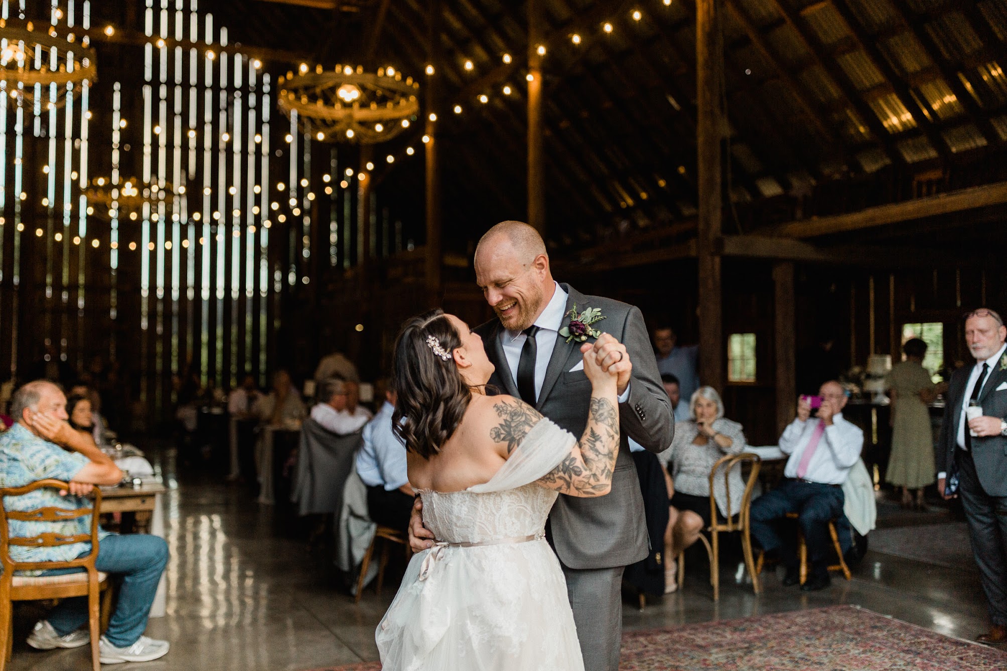 a large rug is being used as the dance floor in this rustic barn