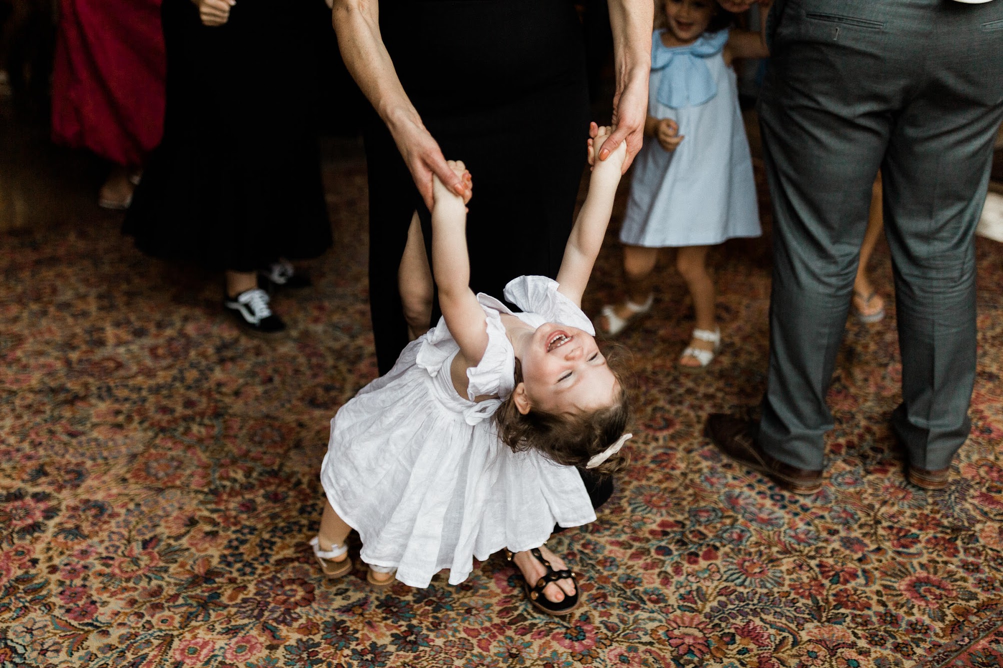 a little girl dancing with her mom 
