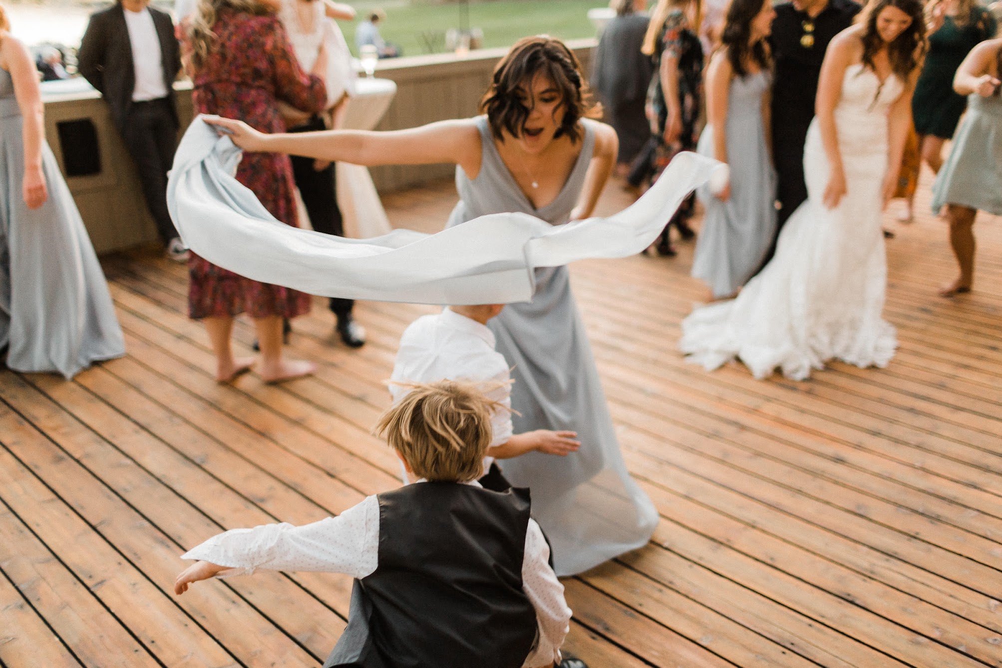bridesmaid dancing with a little boy 