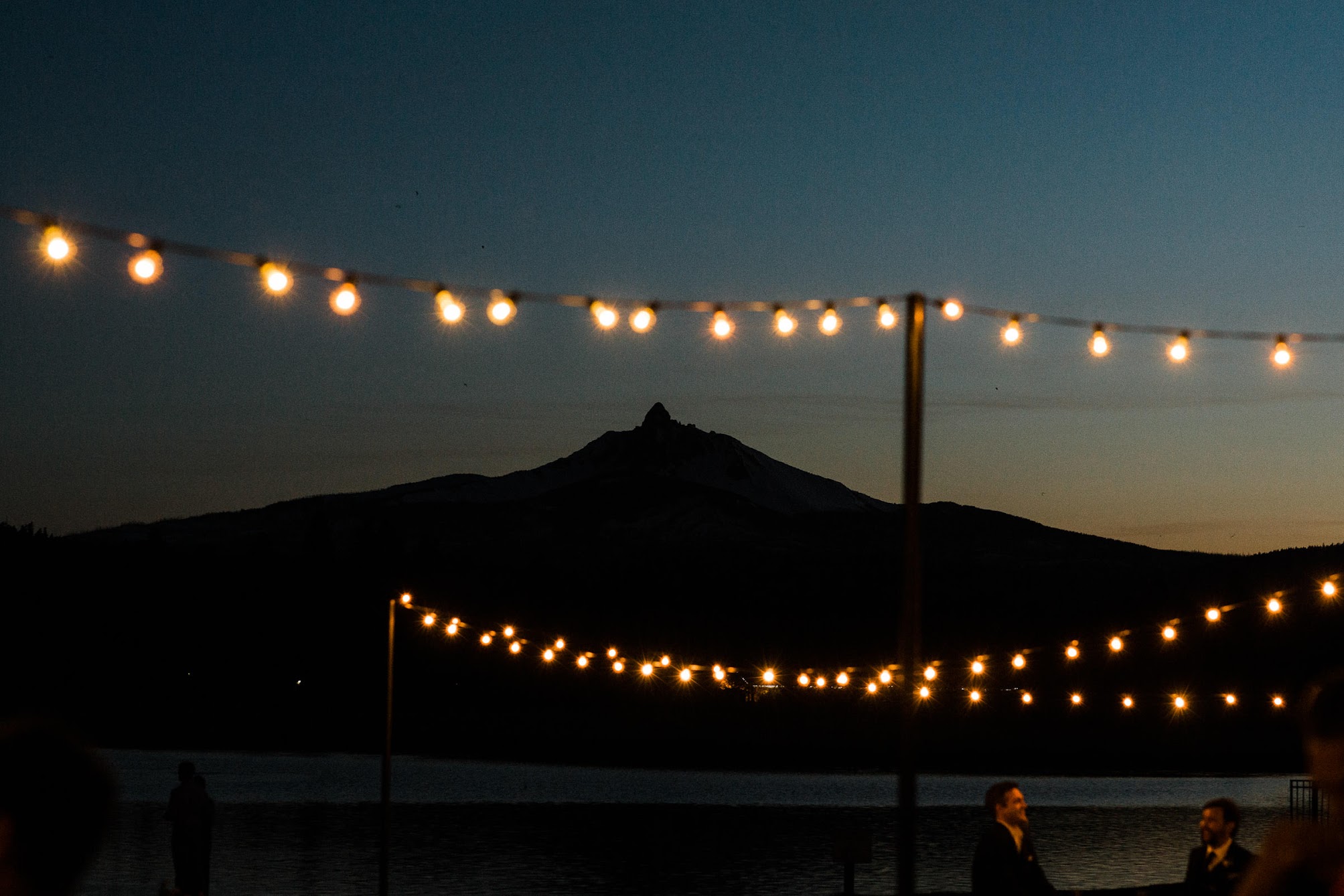 bistro lights with the outline of the mountain 
