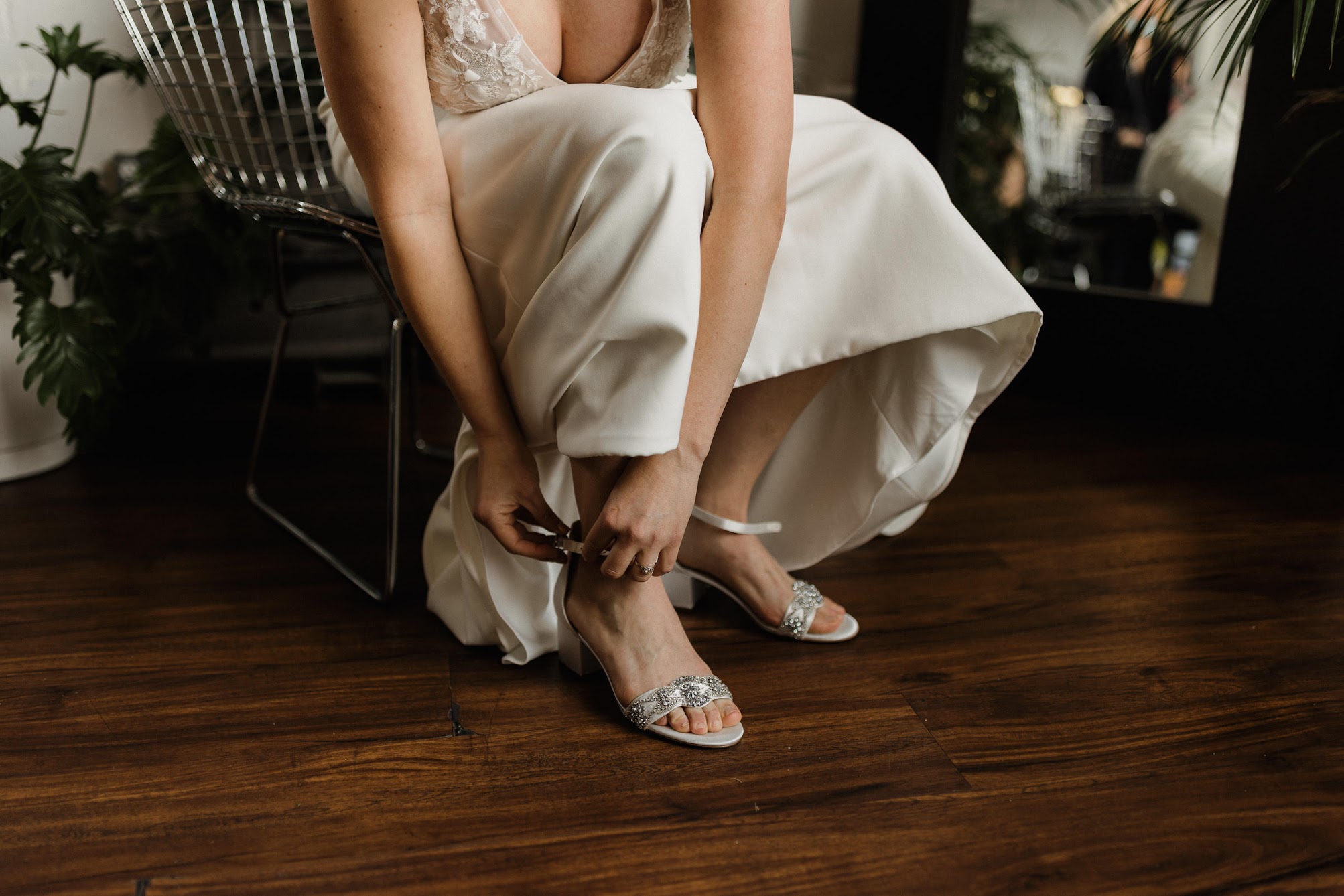 women putting on her wedding shoes 